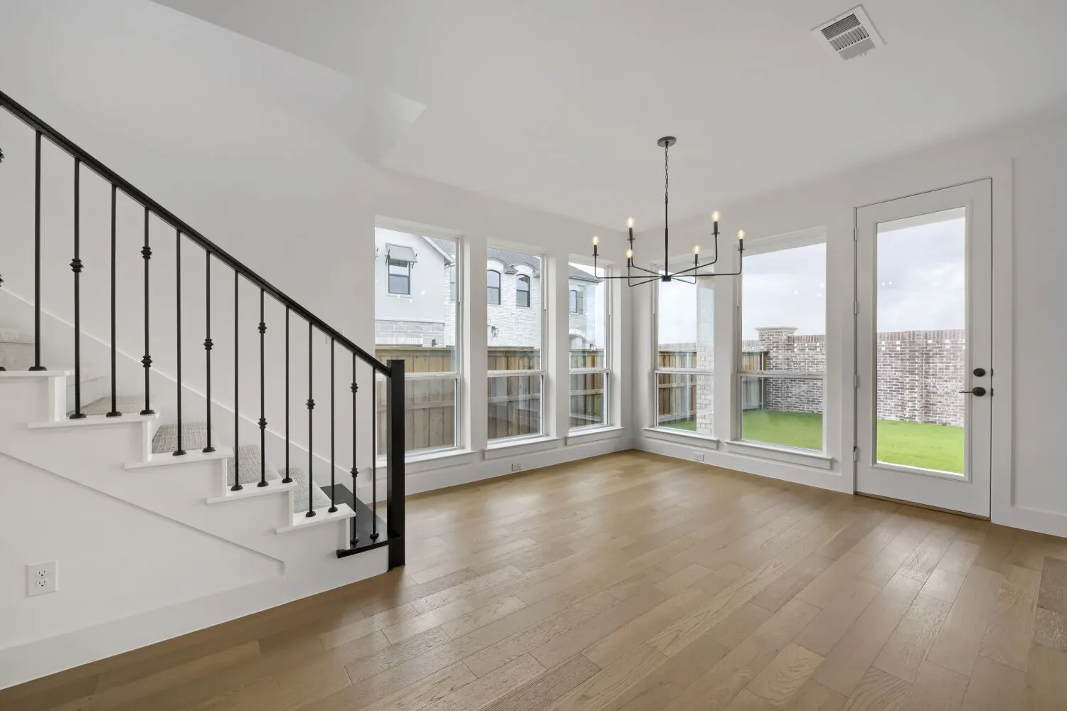 Dining room with walls of windows and wood floors