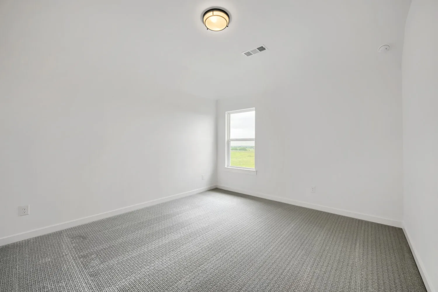 Room featuring light gray patterned carpet and a single window