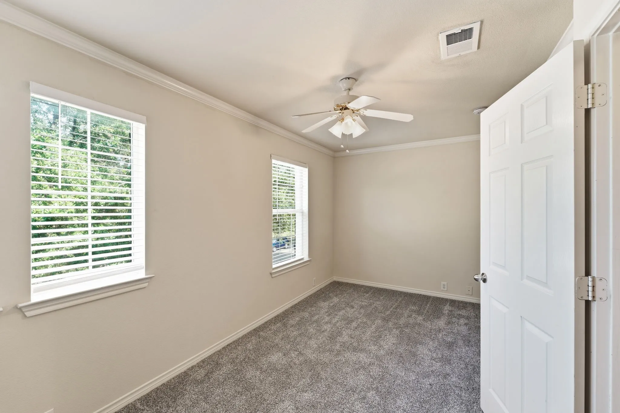 Comfortable second bedroom featuring fresh paint, new carpet, and abundant natural light.