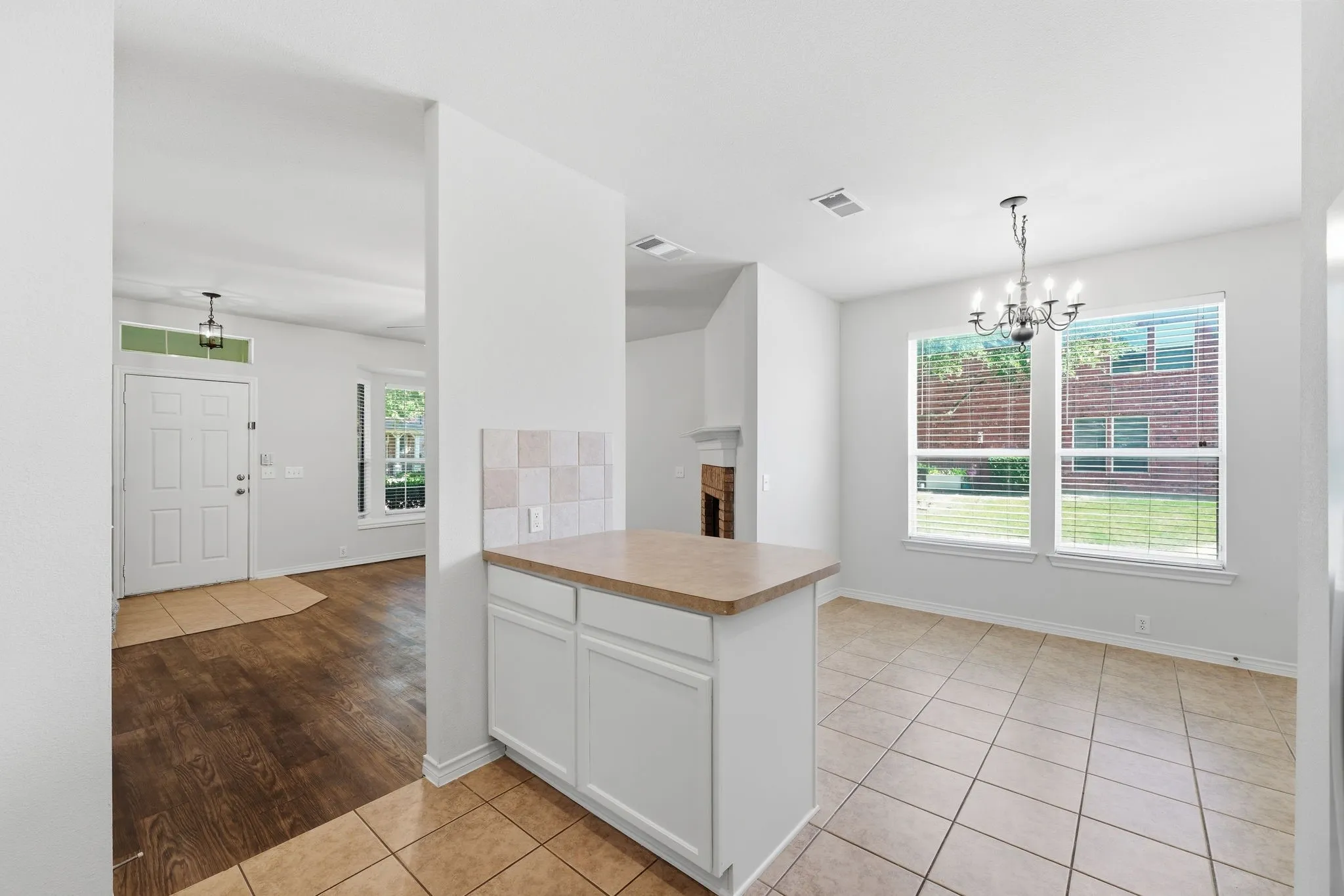 Unstaged view of the open kitchen and breakfast area with great natural light and an easy flow into the living space.
