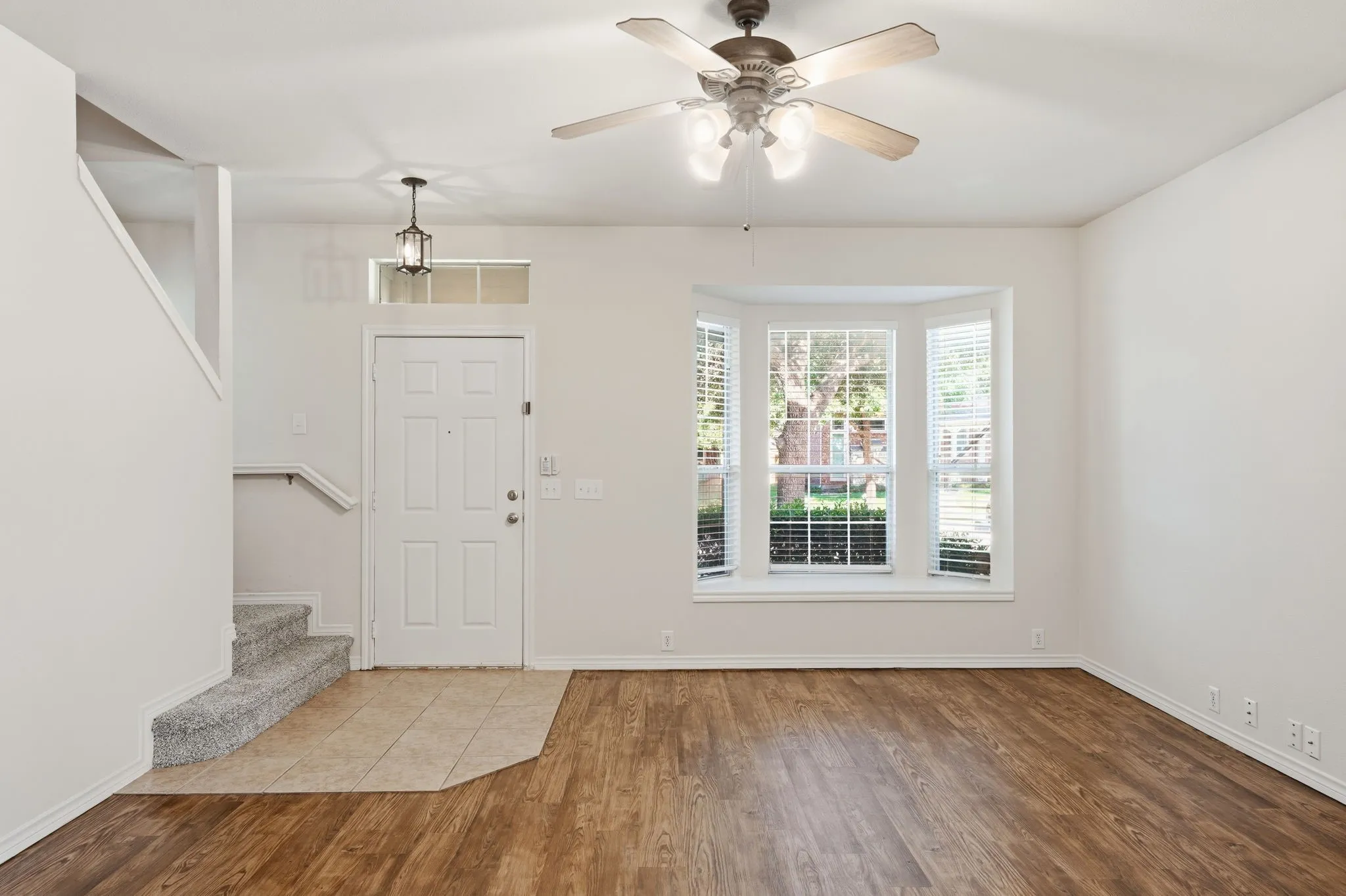Unstaged view of the living room featuring abundant natural light and fresh interior paint.