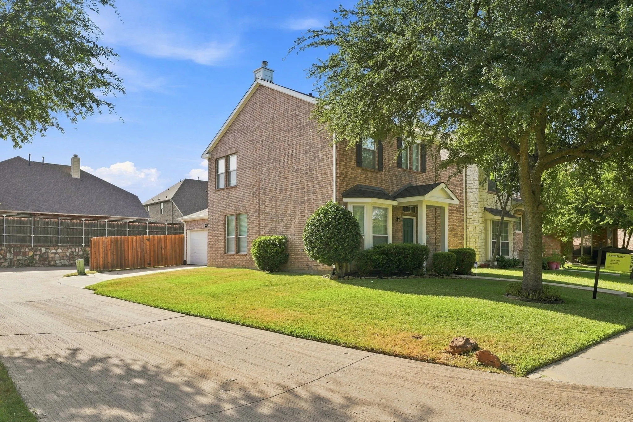 Corner-lot setting with a private driveway and easy garage access.