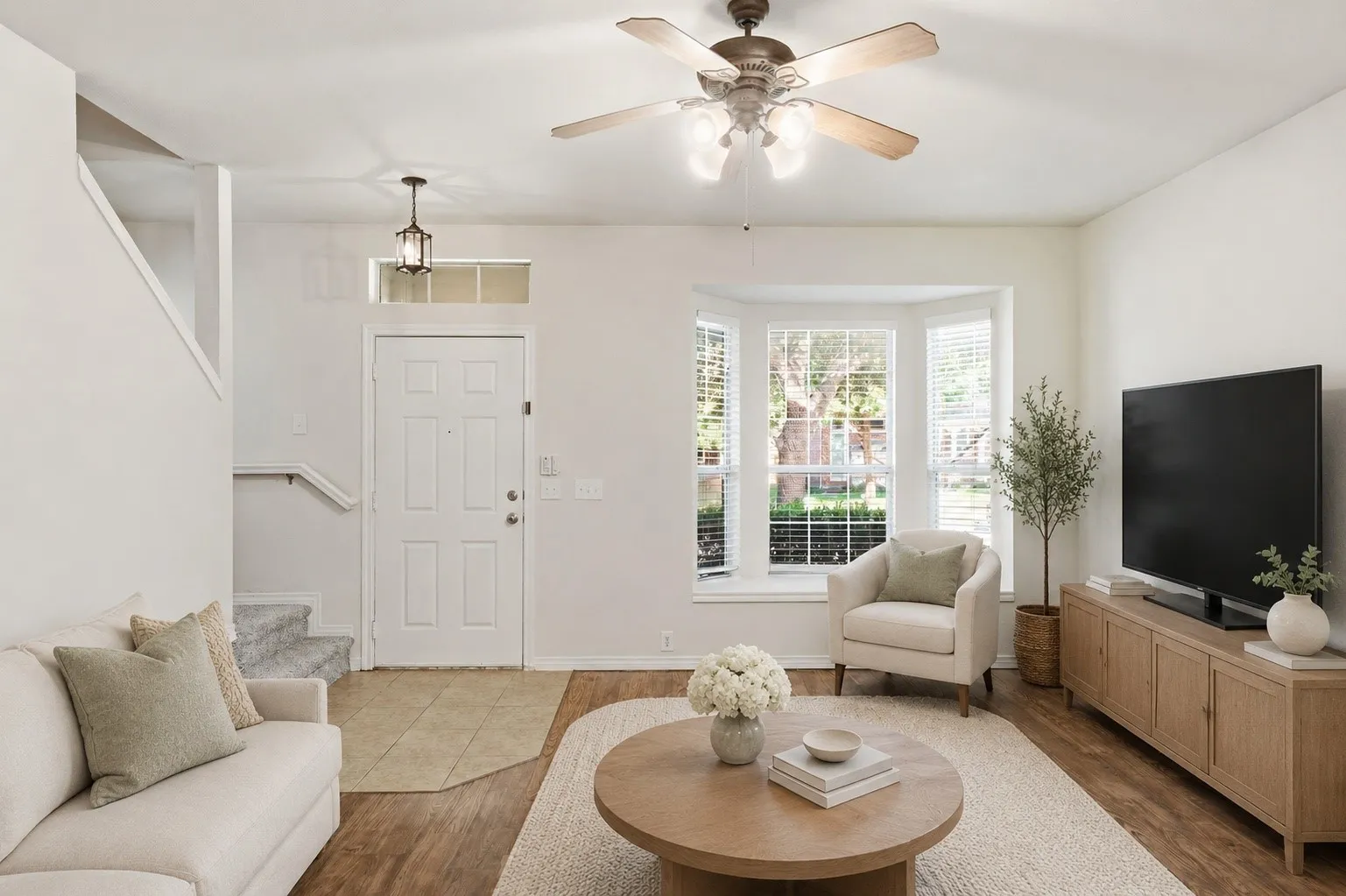 Virtually staged living room highlighting the home’s bright, inviting layout and bay window.