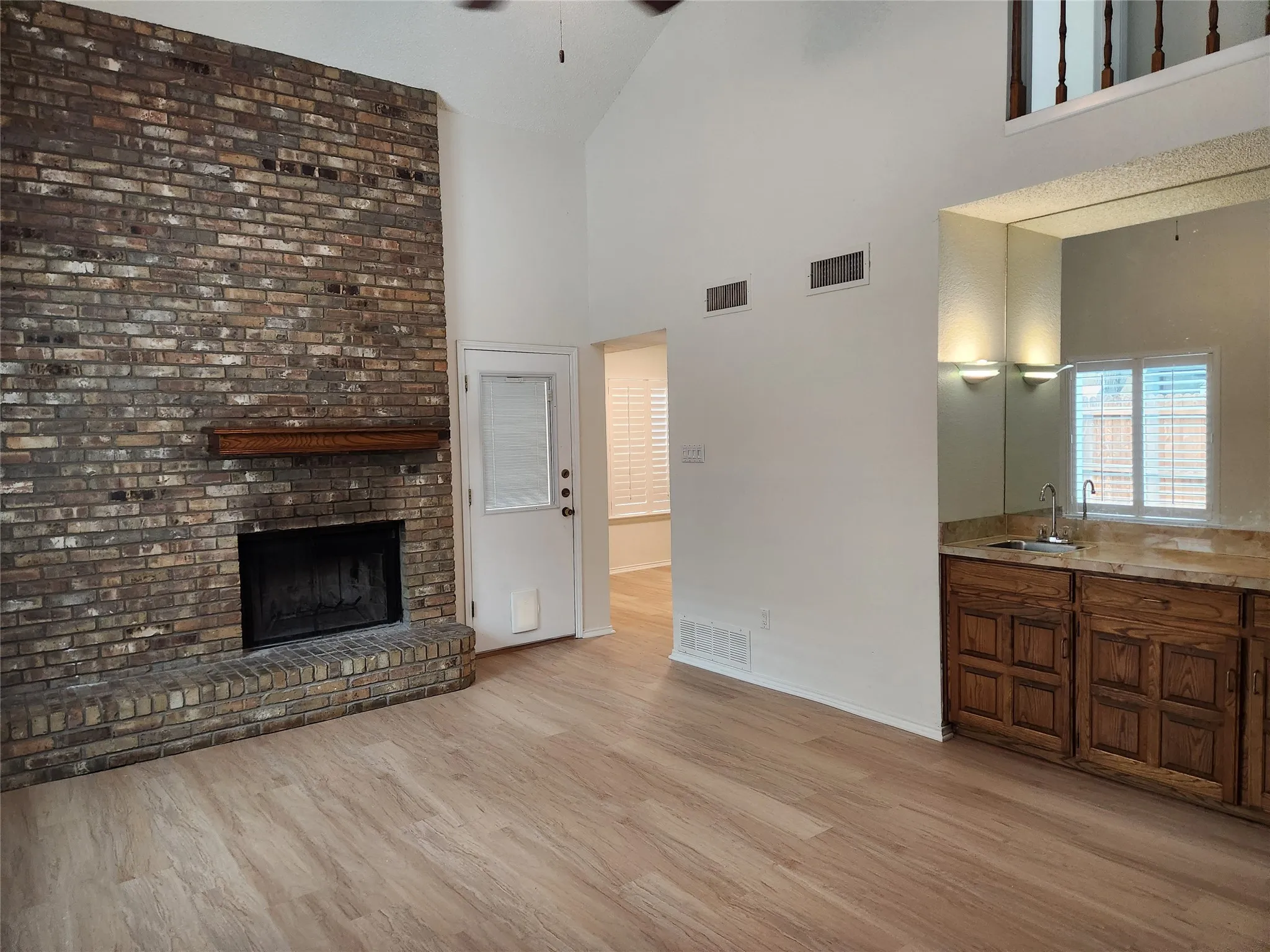 Brick fireplace with a wood mantel