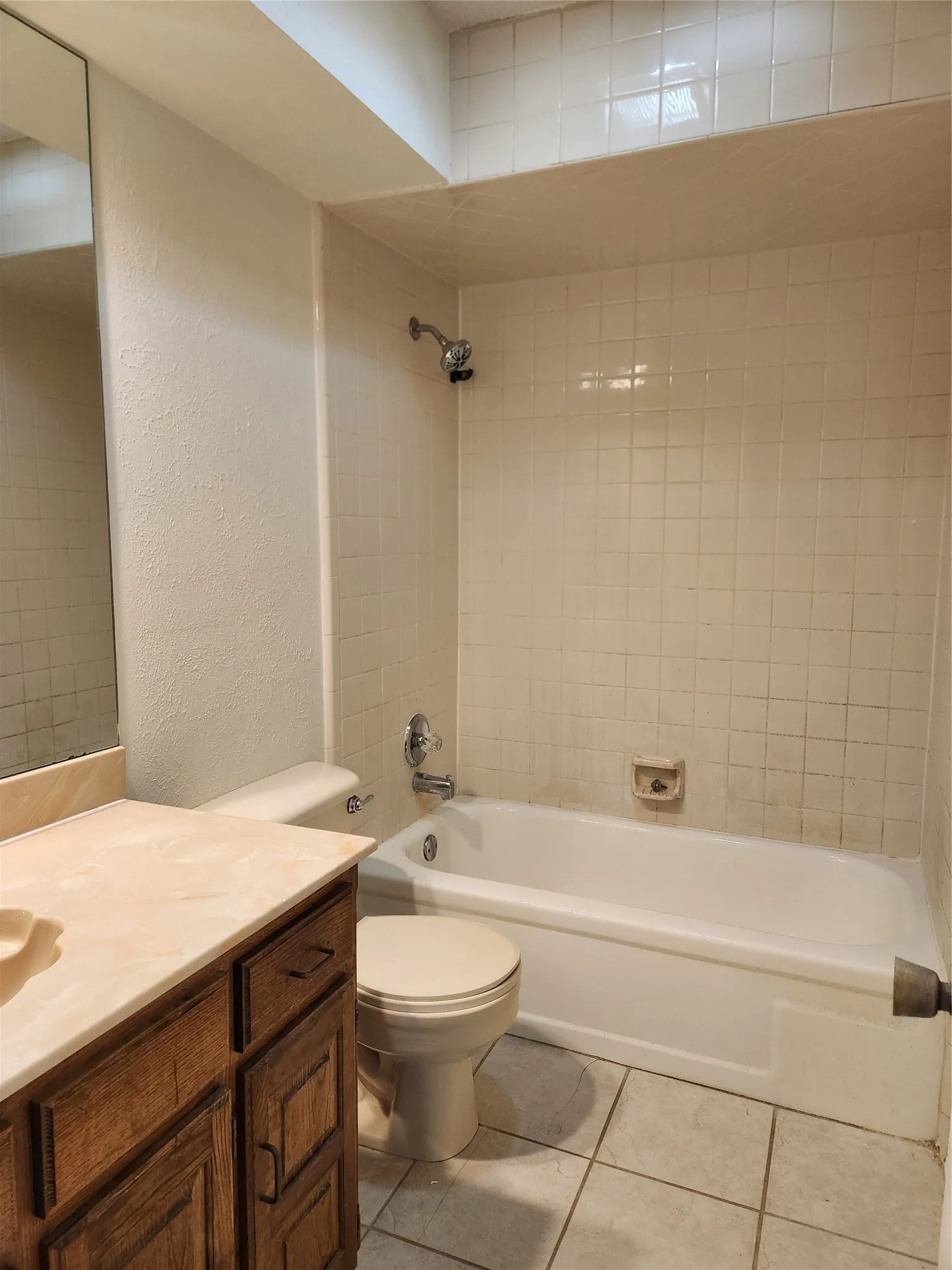 Wood-finish flooring, mirrored sliding closet doors, ceiling fan, and window with blinds