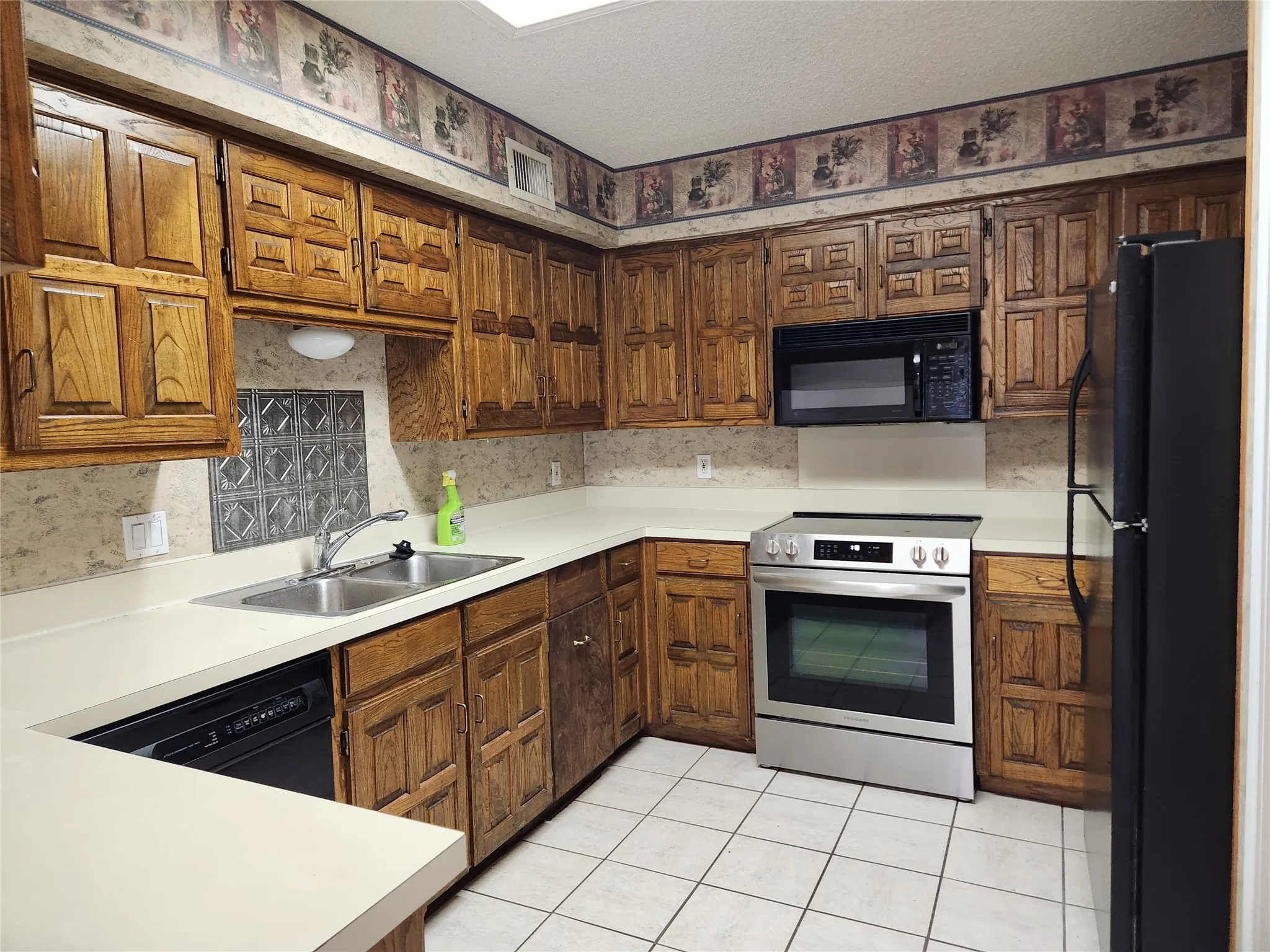 Kitchen featuring wood cabinetry, stainless steel range, and built-in microwave