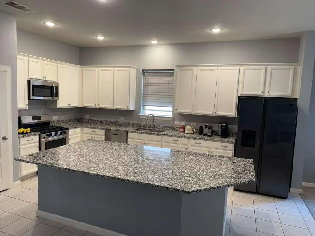 Lovely open kitchen with granite, stainless appliances and a large walk in pantry
