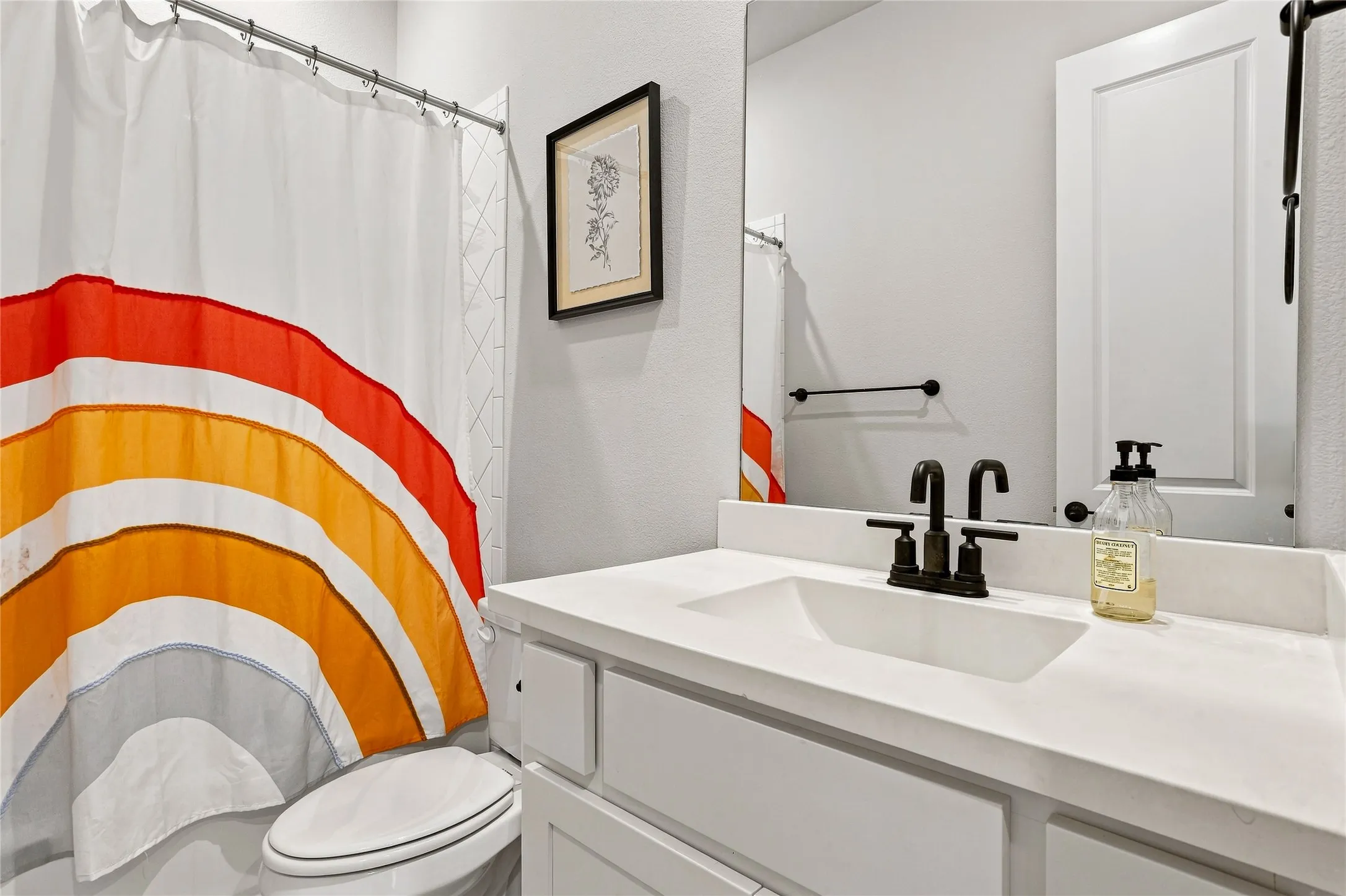 White vanity with integrated rectangular sink and dark bronze faucet