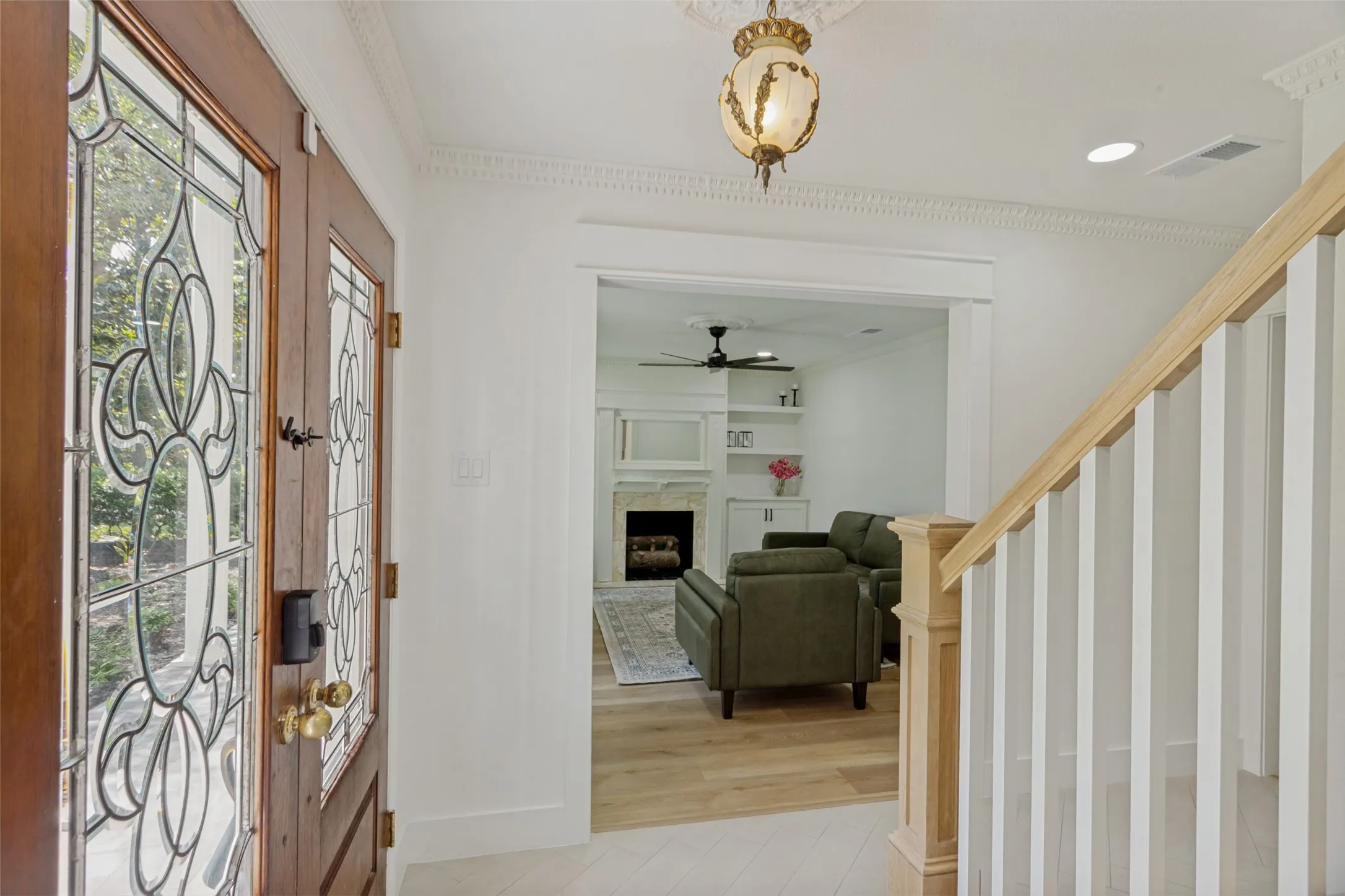 Wood-paneled front door with leaded glass inserts