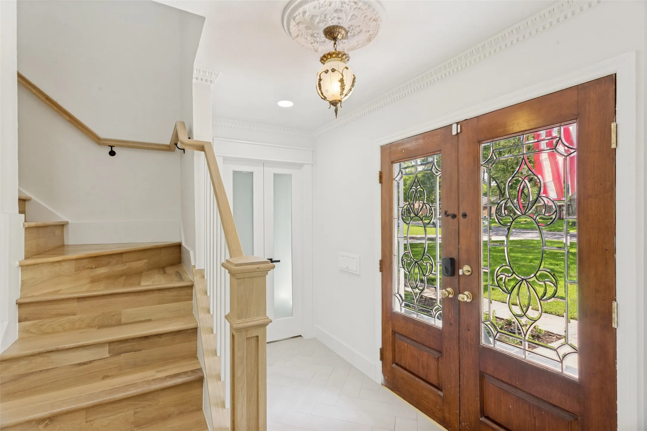 Wood-finish staircase with light wood newel post and handrail