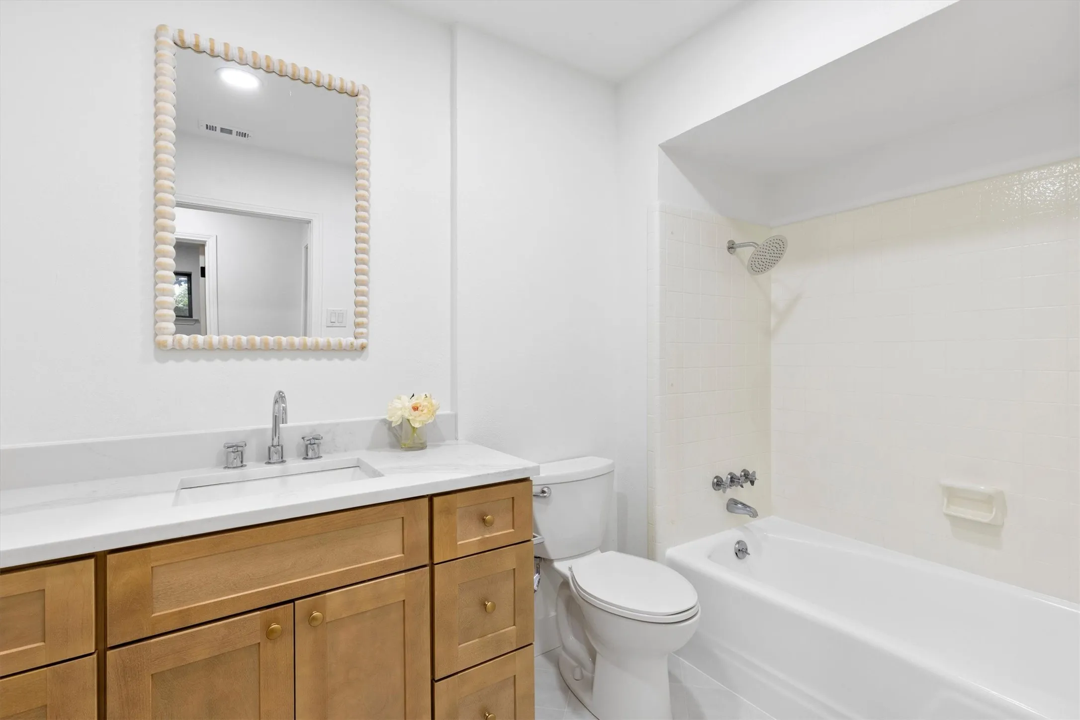Wood-finish vanity with a white countertop