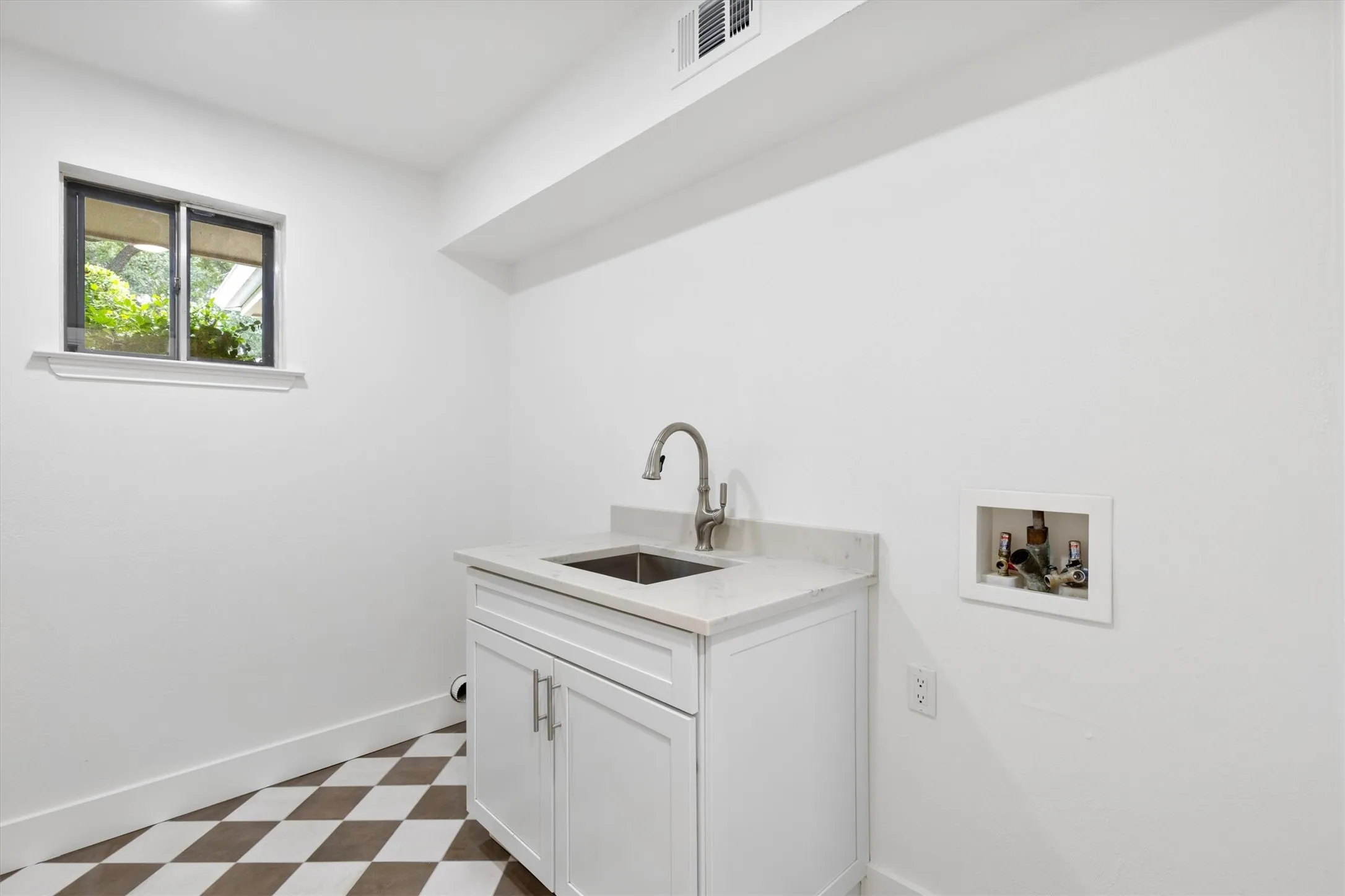 laundry room with stand alone sink cabinet