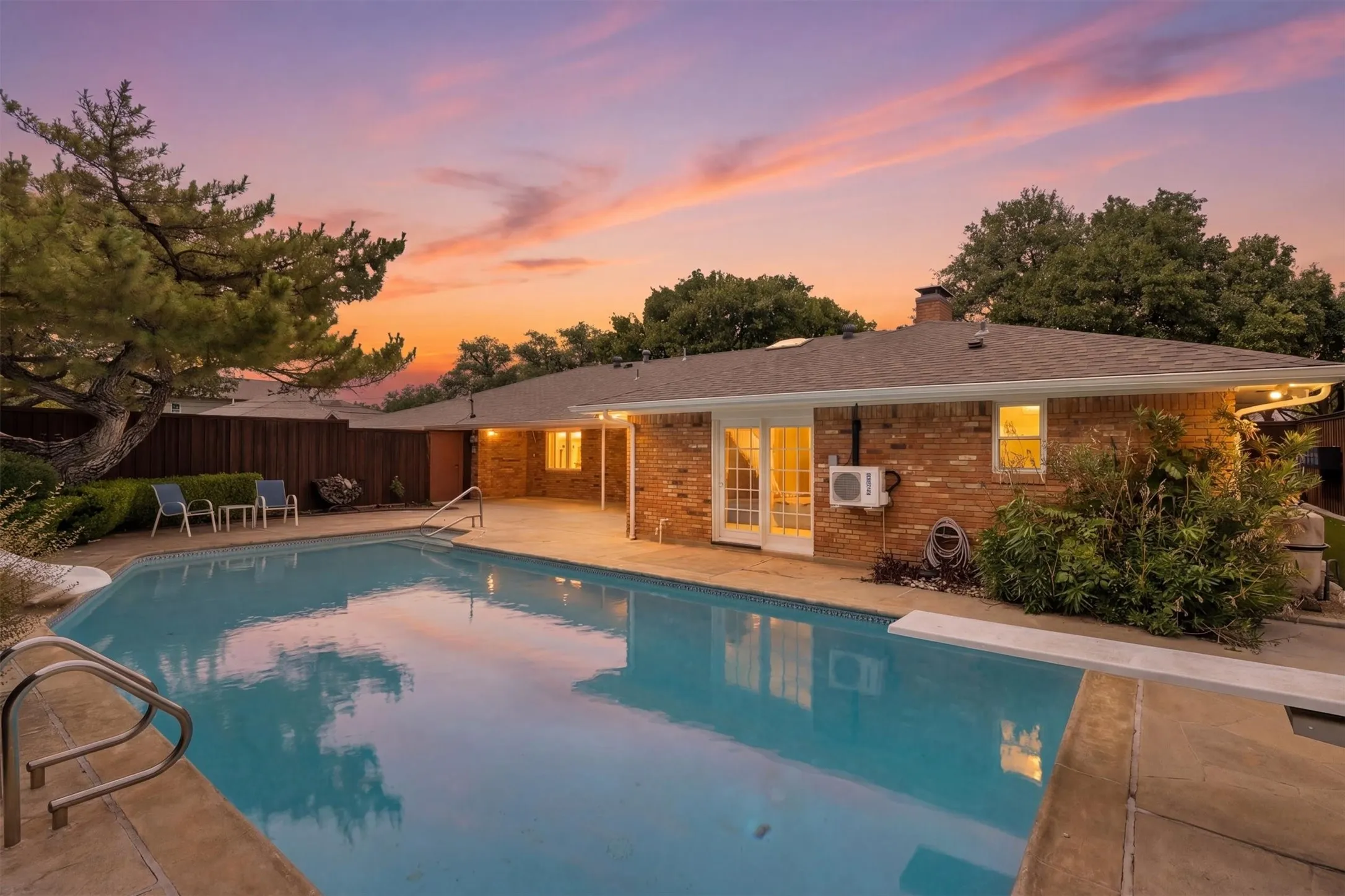 Expansive swimming pool with integrated diving board and entry rails