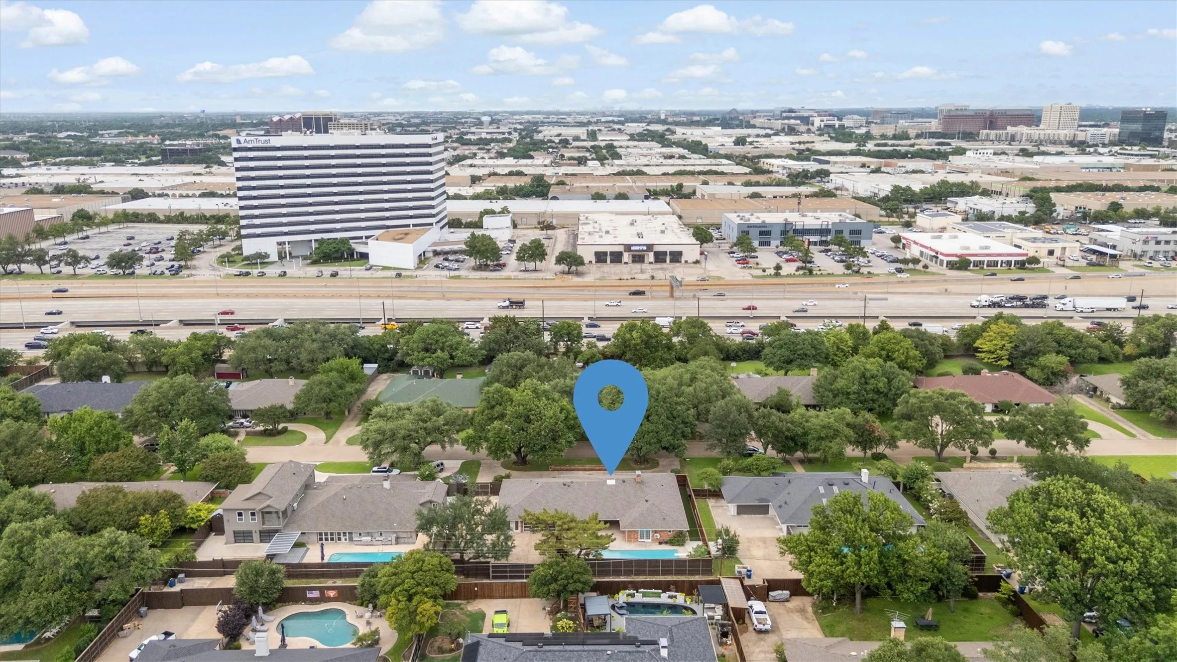 Residential neighborhood with mature trees, established properties, and a private swimming pool