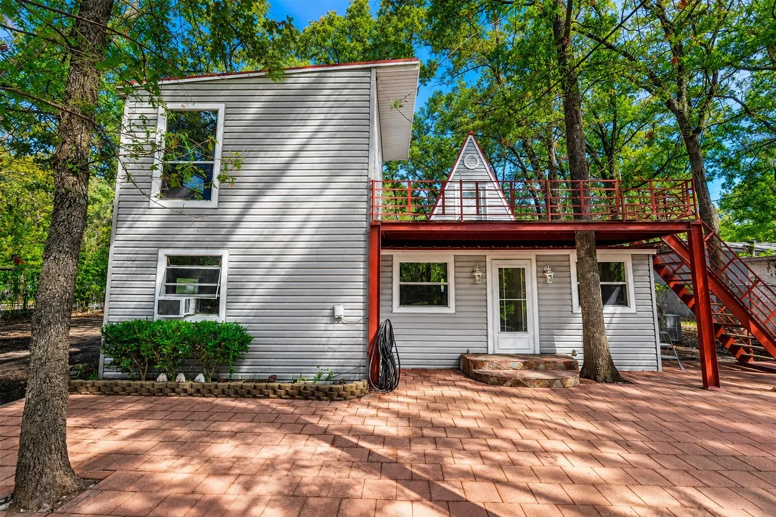 View of back patio and upstairs deck