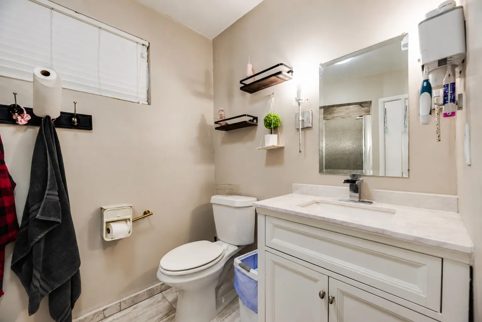 White vanity with a rectangular sink and a single-handle chrome faucet