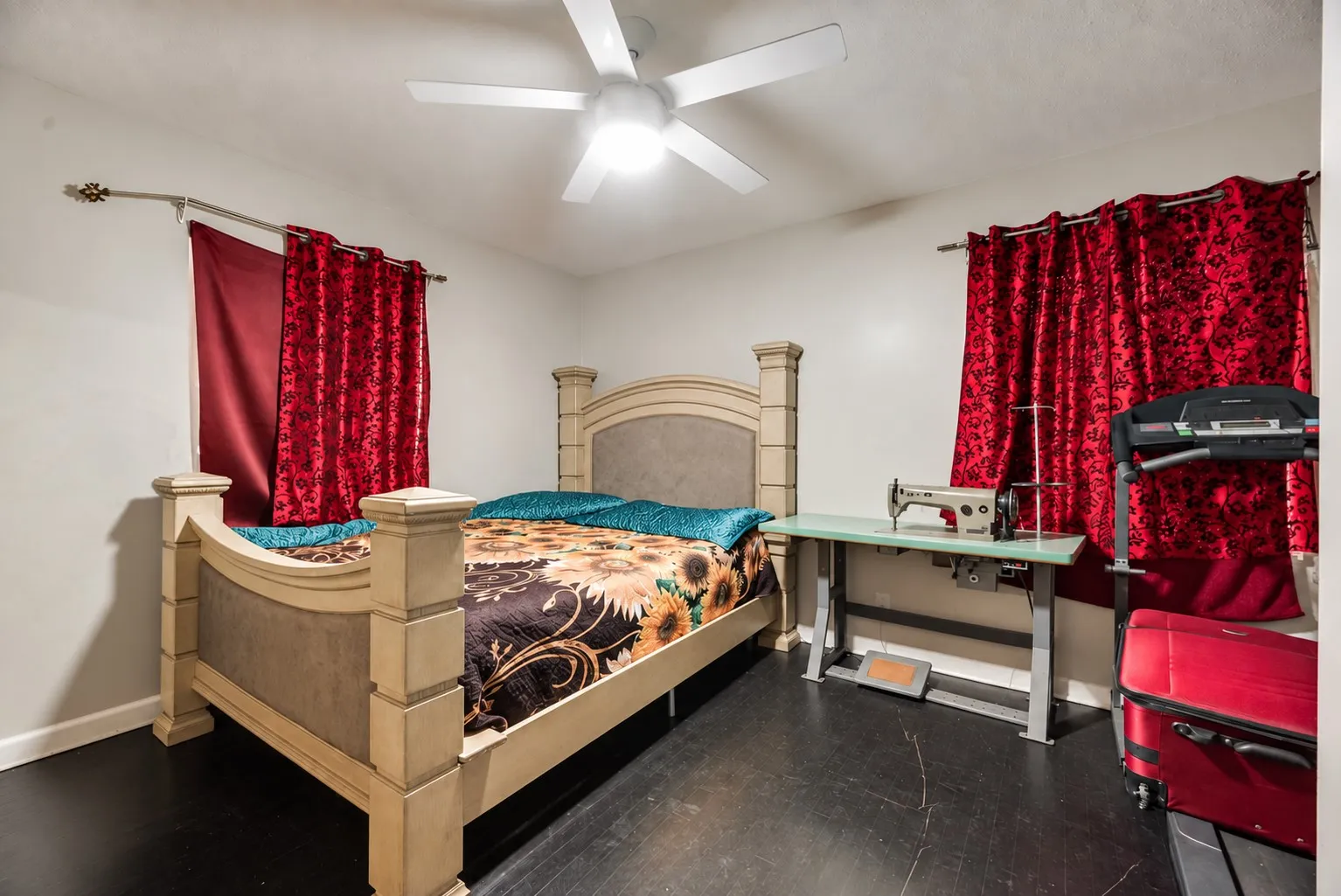 Recessed lighting, ceiling fan, and dark-toned flooring