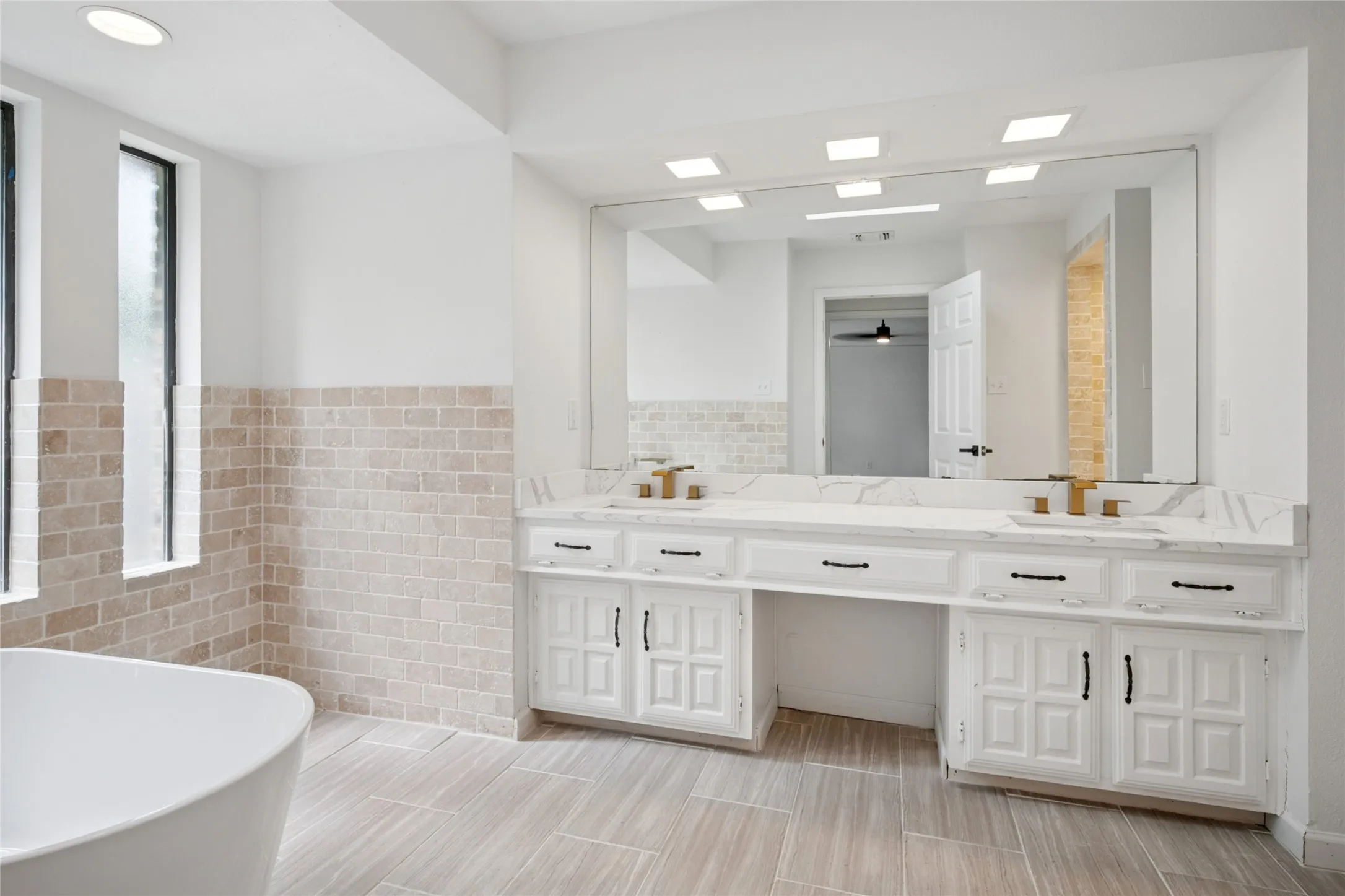 Primary bath has double sinks and separate tub