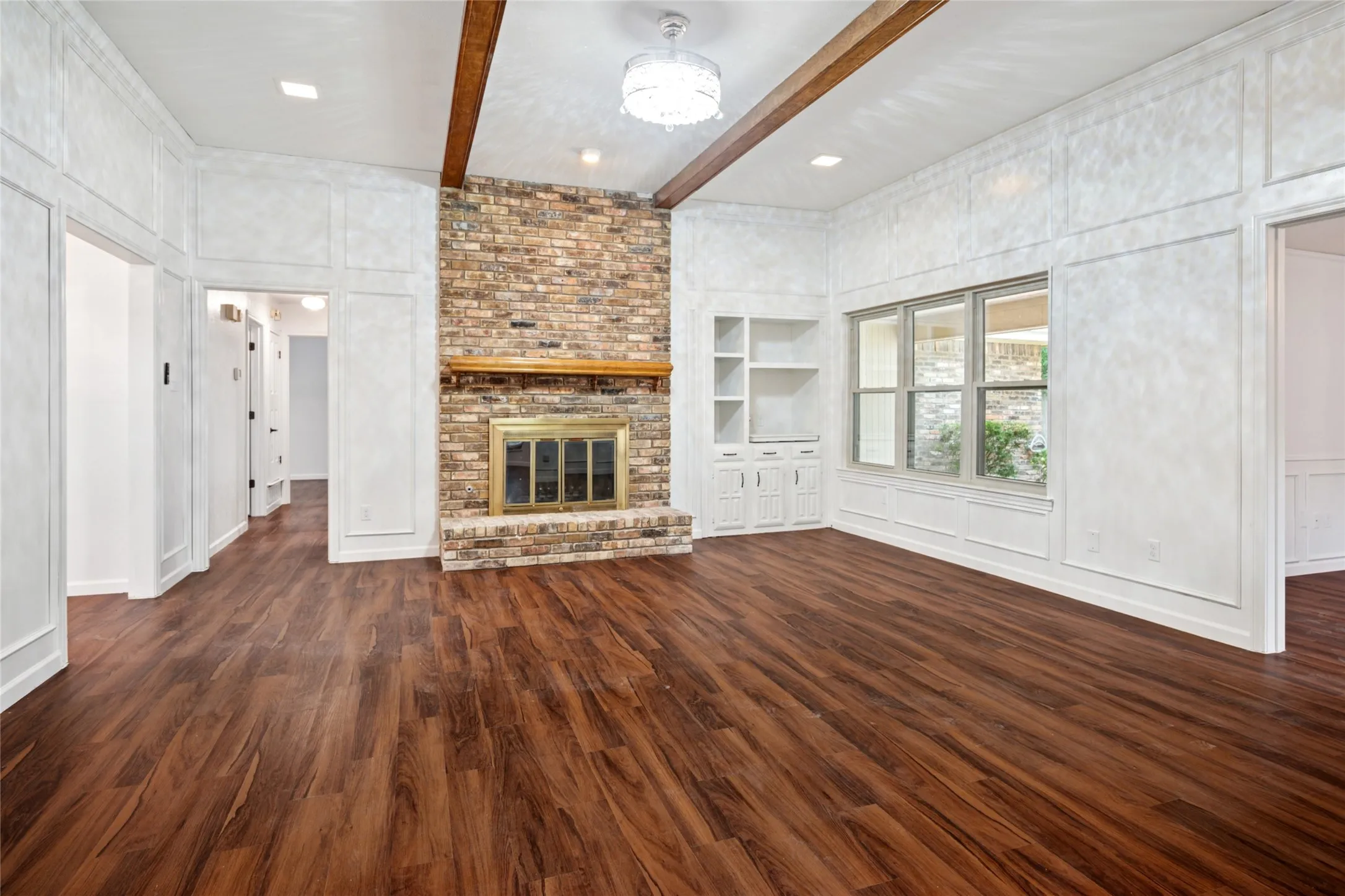 Family room with brick fireplace and built-ins