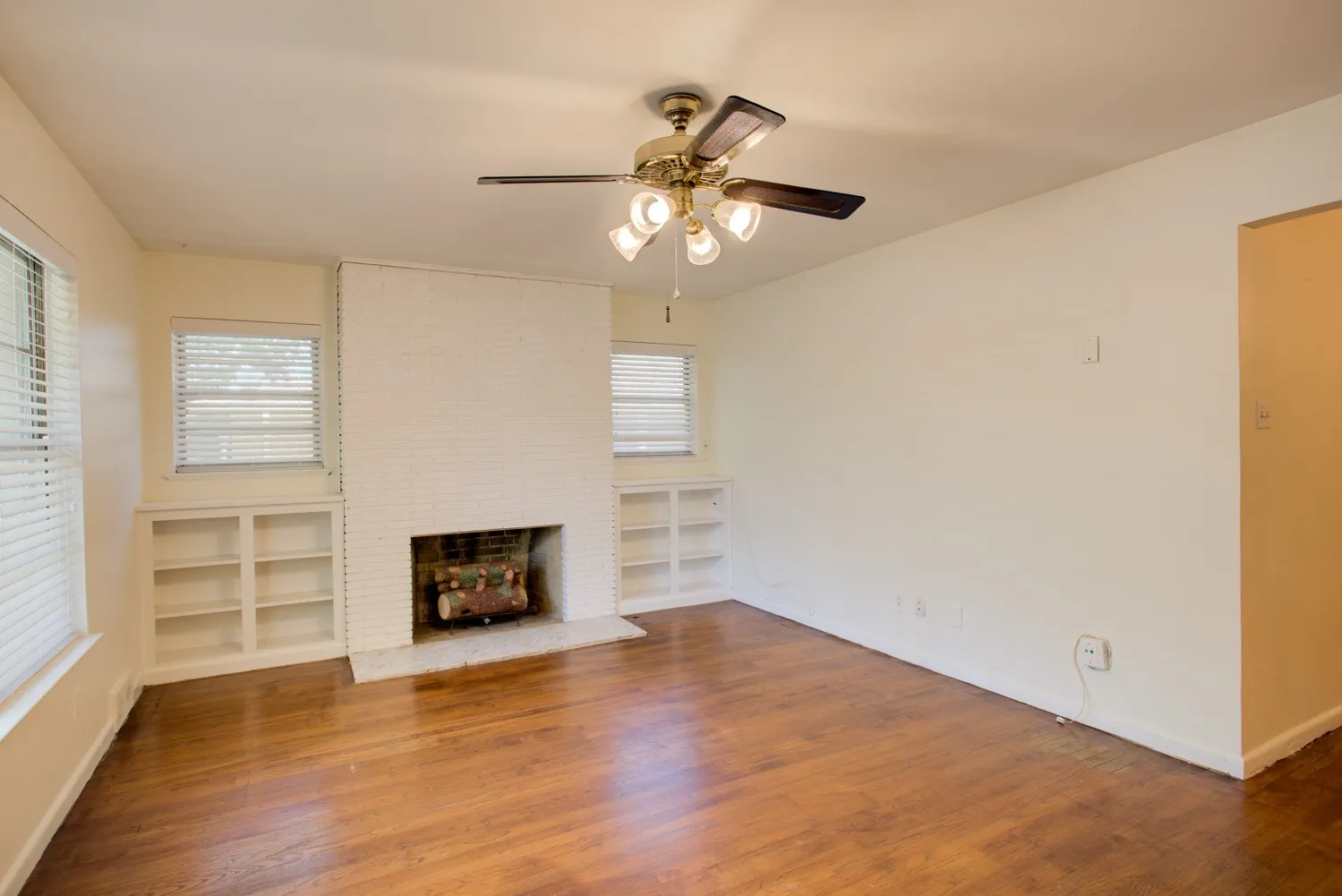 Living Room with hardwood floors, fireplace, and built-in shelving