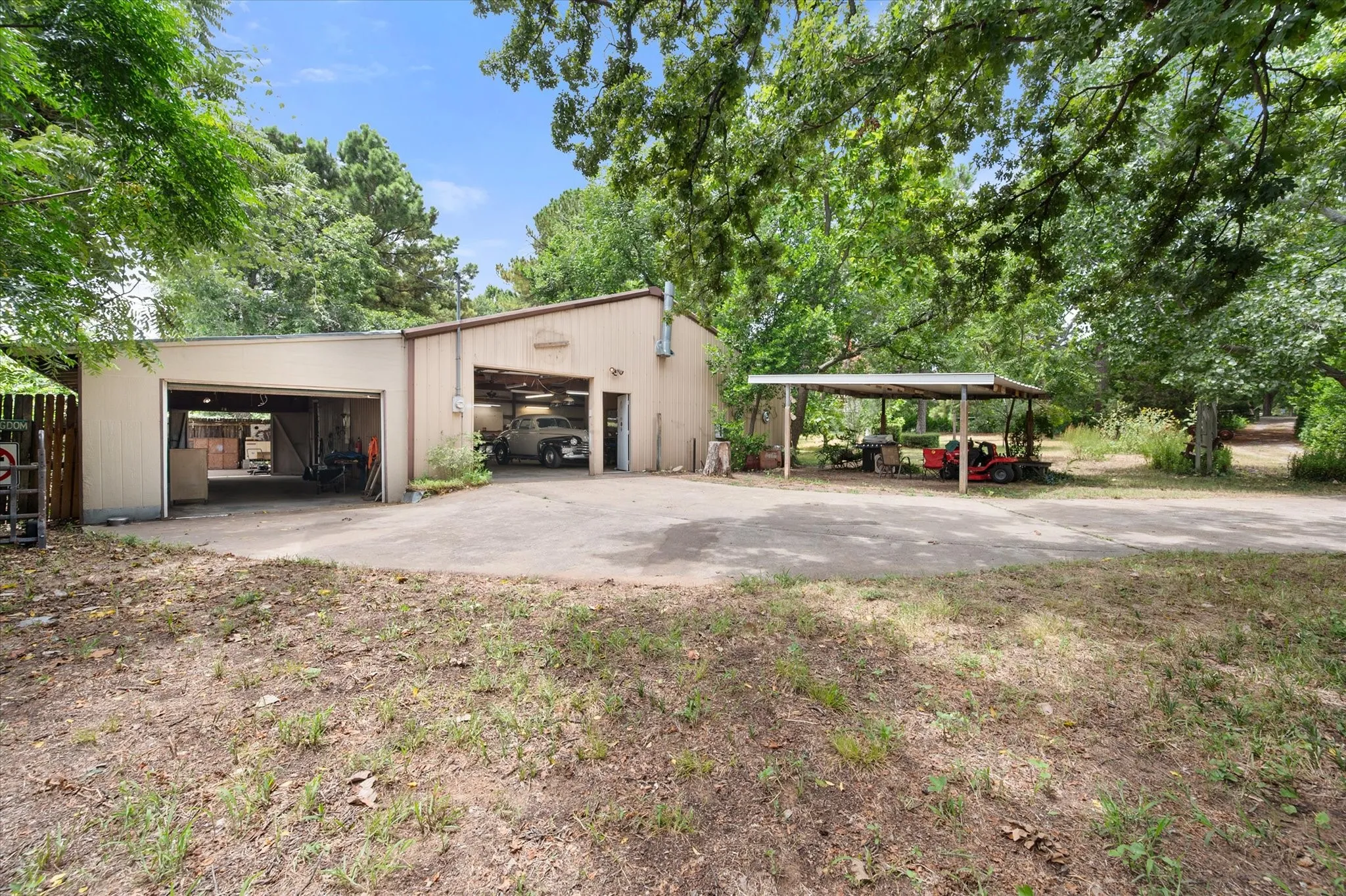 Gated drive leads to the 40x40 insulated metal shop on concrete with industrial heat pump,
thermostatically controlled vintage wood-burning stove, space for up to 6 vehicles plus 20x14 office area with
cabinetry, sink, fridge & desk.