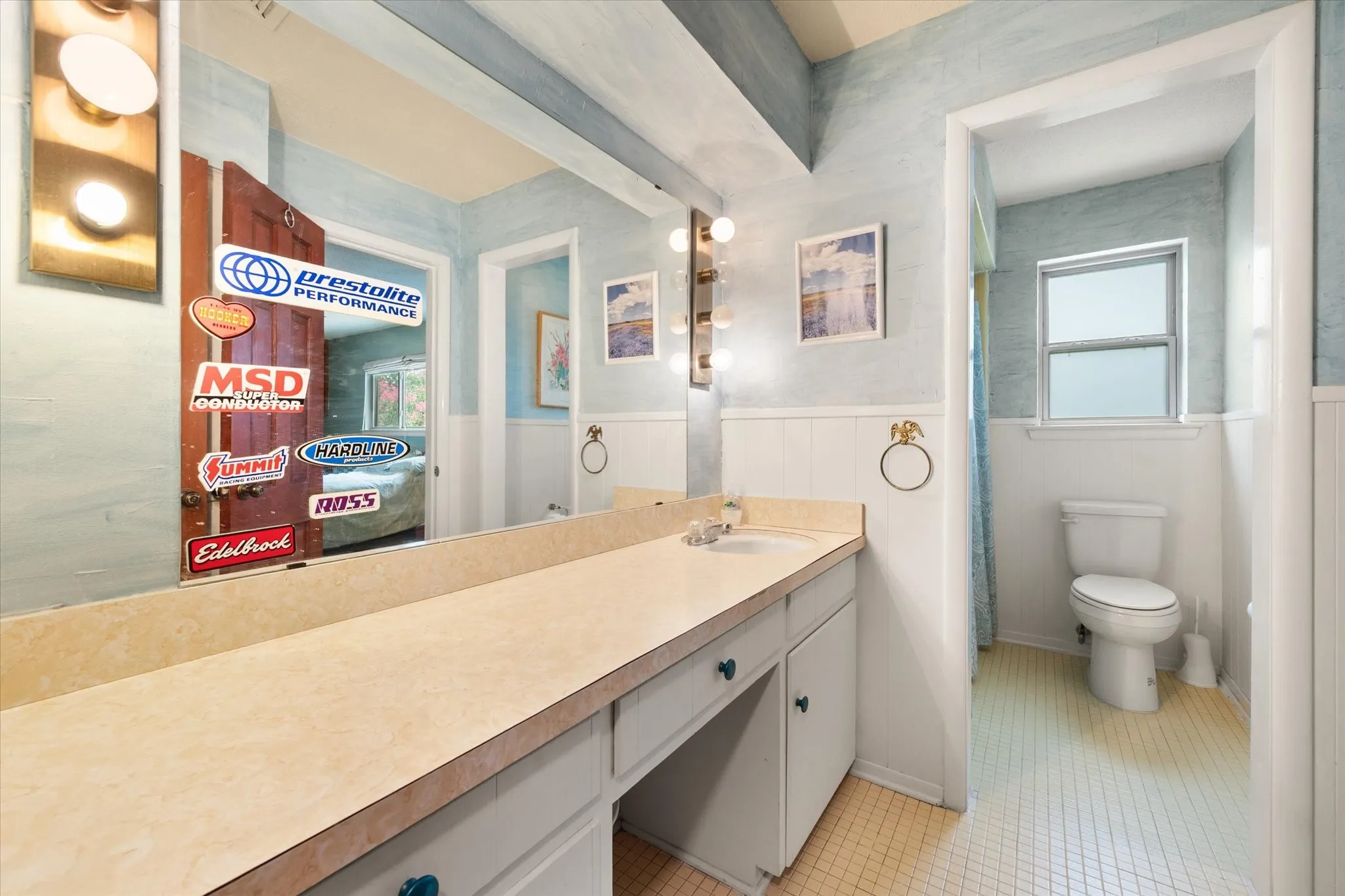Upstairs Bathroom features a vanity with an integrated sink and base cabinetry