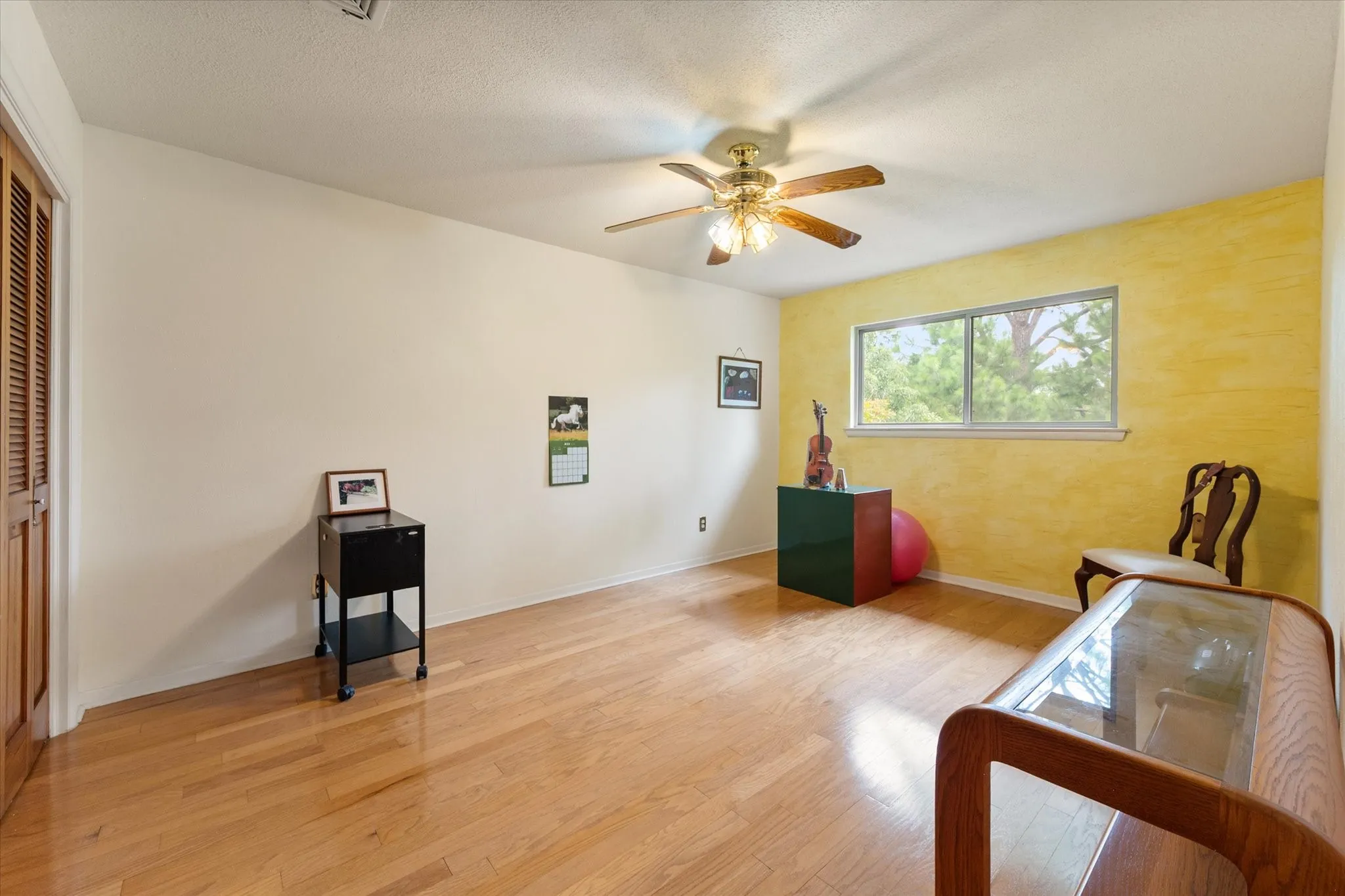 Bedroom 3 has a ceiling fan and window overlooking the backyard.