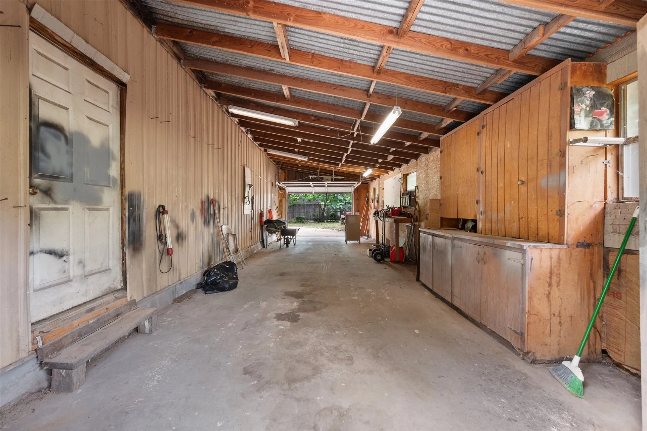40 x 13 addition to the shop features concrete flooring a corrugated metal roof and room to park two more vehicles.