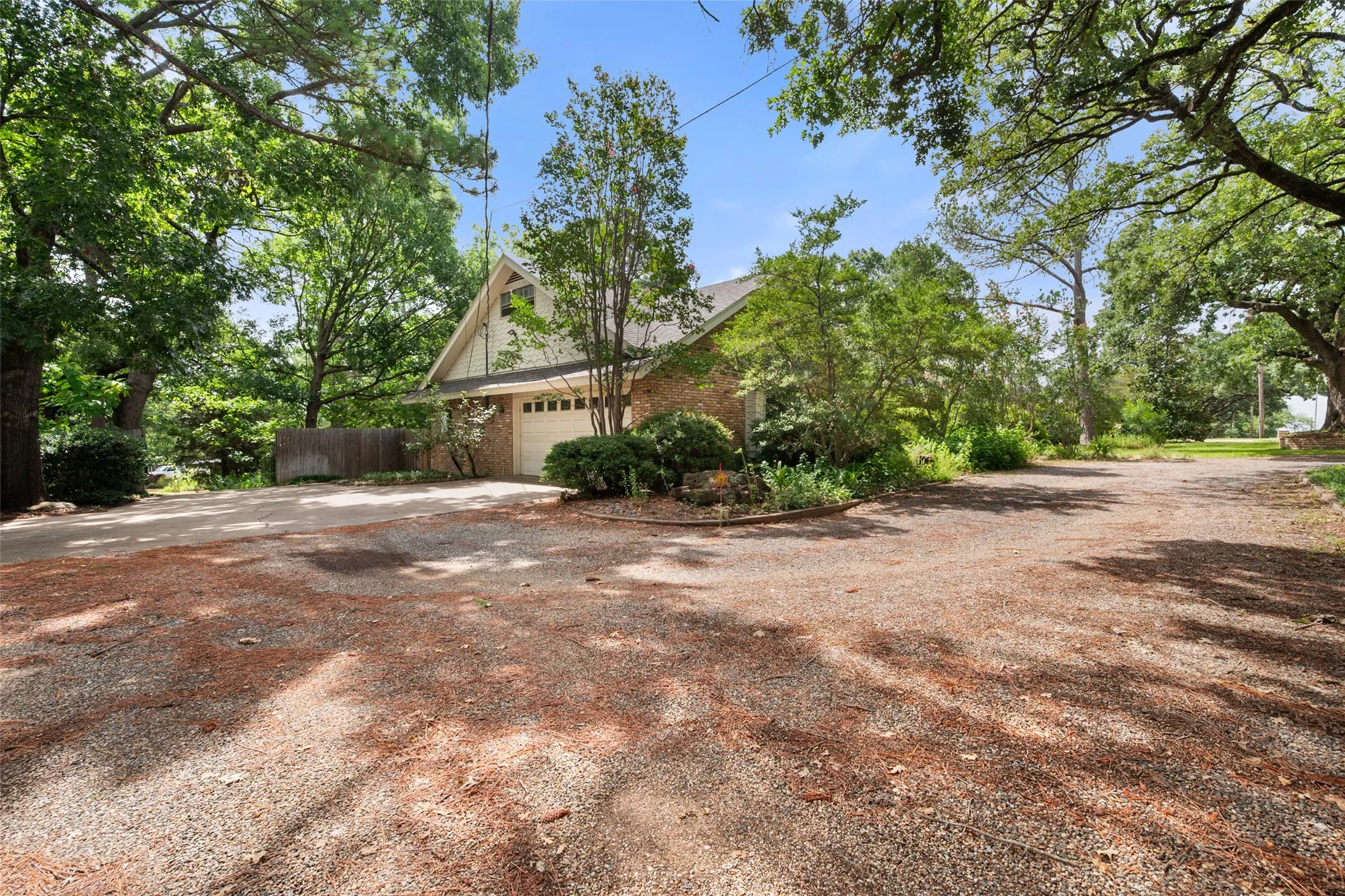 Side driveway provides access to the oversized two car side entry garage, the front circle drive and there is a gated drive to the back of the lot.