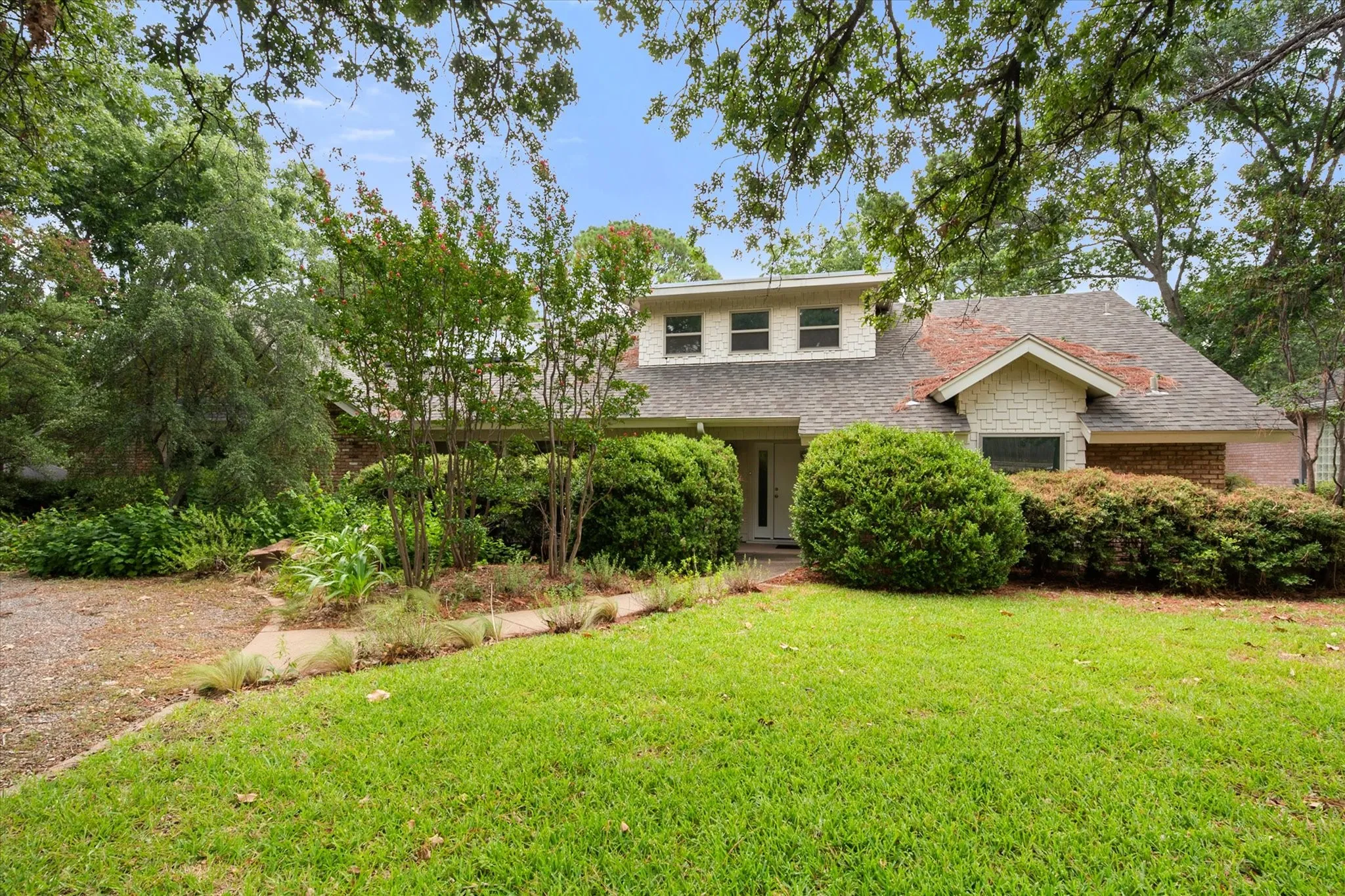 Circle Drive, covered front porch and lusch landscaping add to the curb appeal.