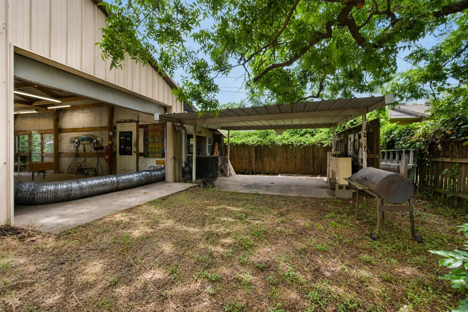 Behind the shop is an attached covered patio with a concrete pad providing covered parking for 2 more vehicles