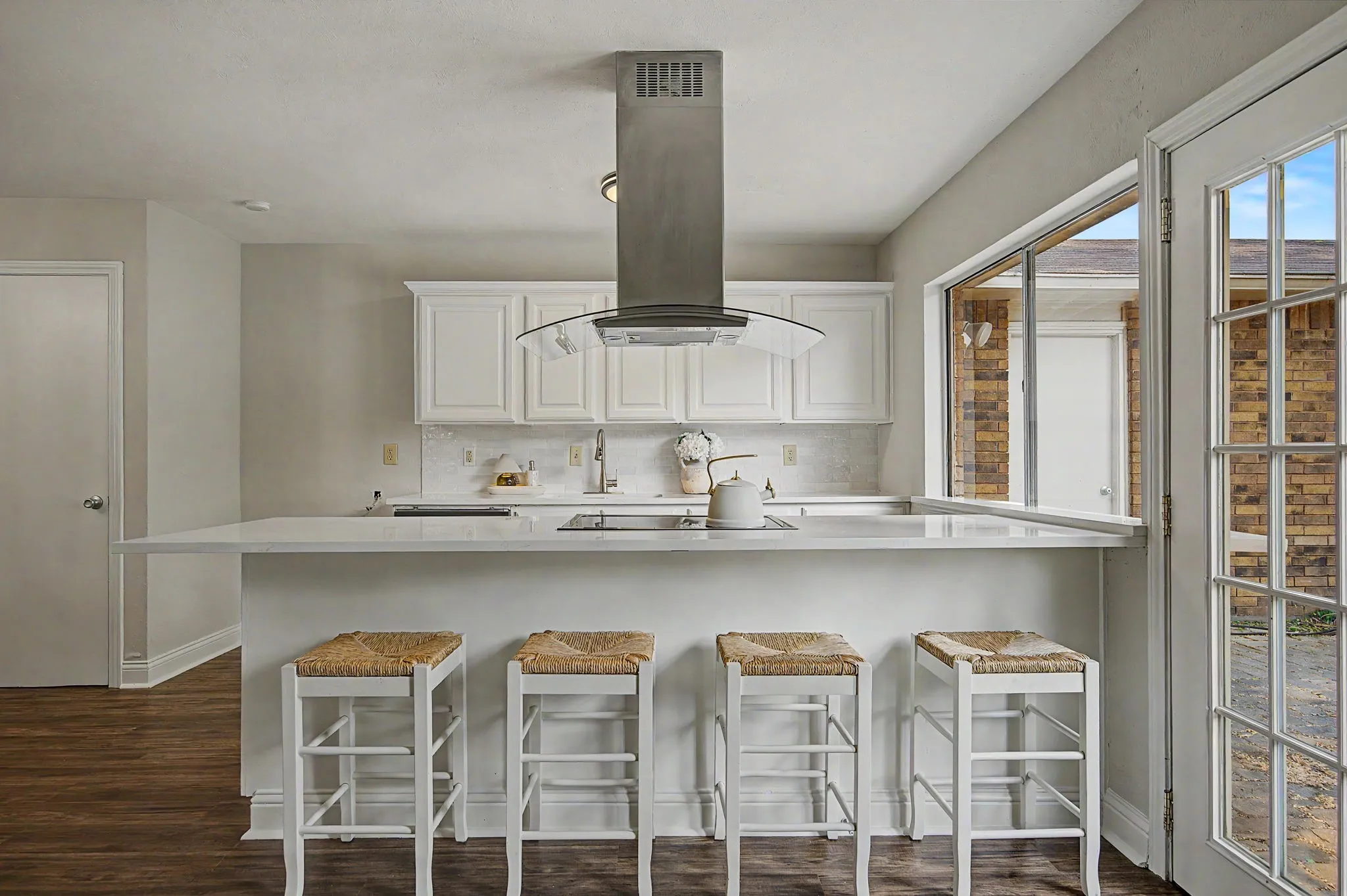 The Quartz counter-tops extend over the island/breakfast bar.