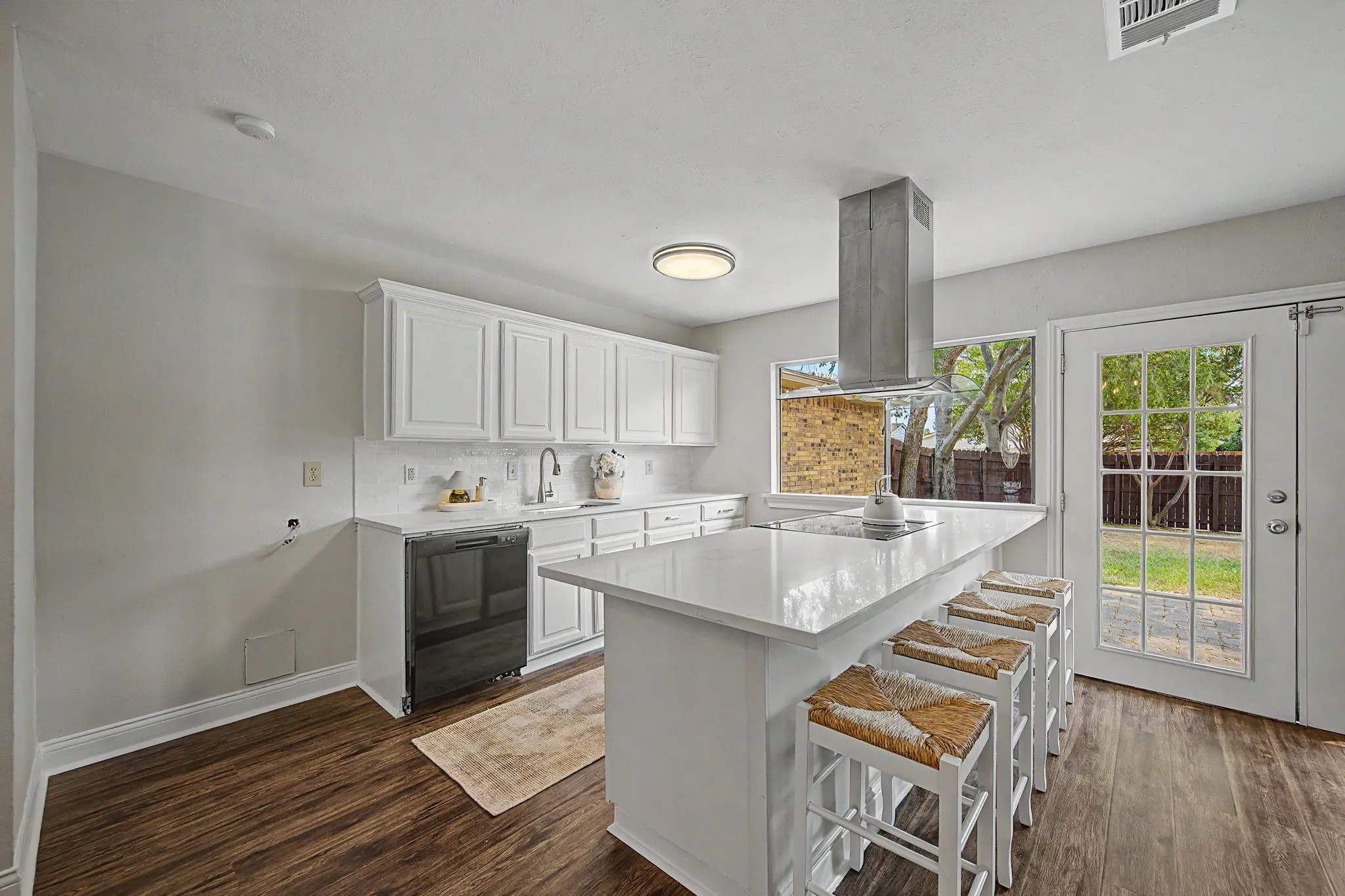 The kitchen is so bright with a pass-through serving window to the outside. Perfect for entertaining!