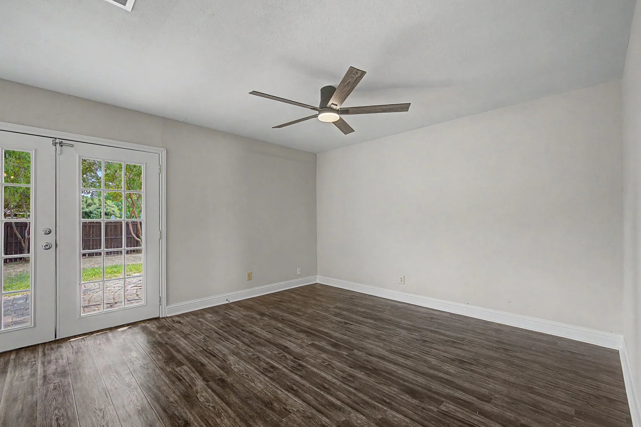 Spacious 2nd living room that is open to the kitchen with French doors that lead out to the back patio and yard.
