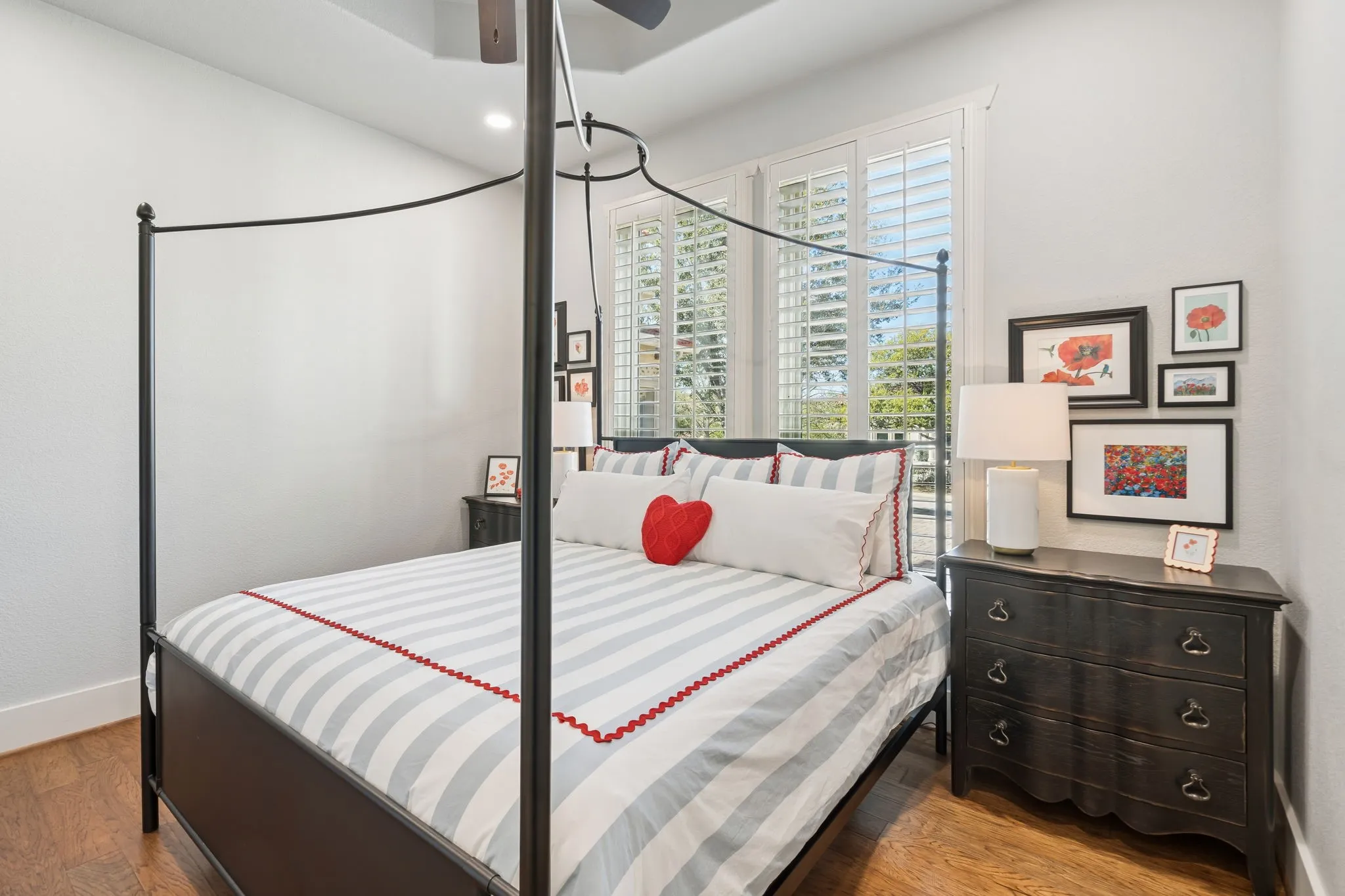 Recessed lighting, wood-finish flooring, and white plantation shutters