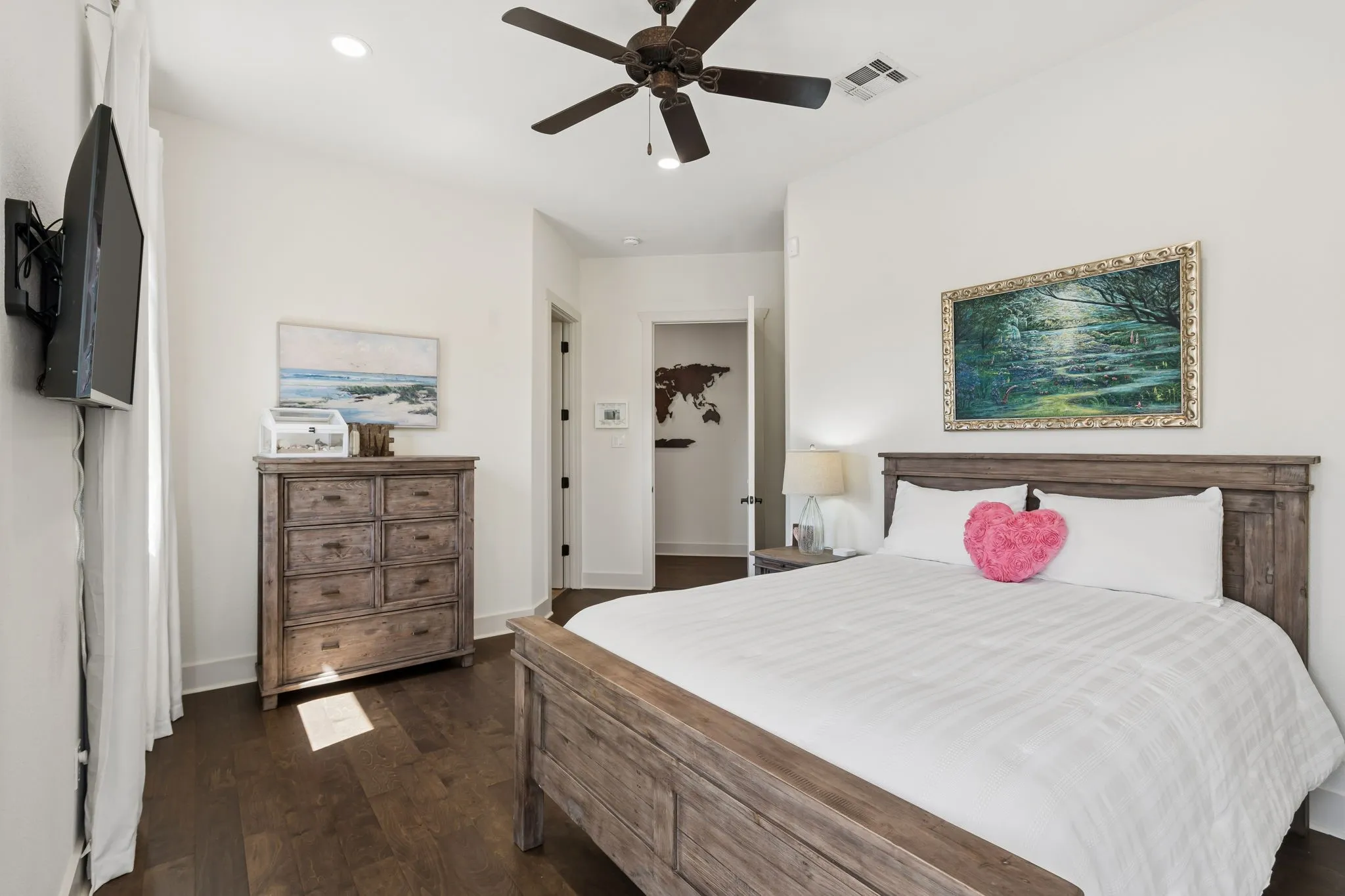 Rich wood-finish flooring, recessed lighting, and a ceiling fan