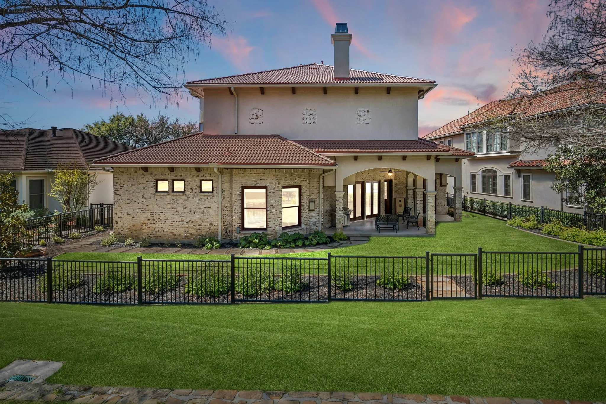 Stucco and brick exterior with a tile roof