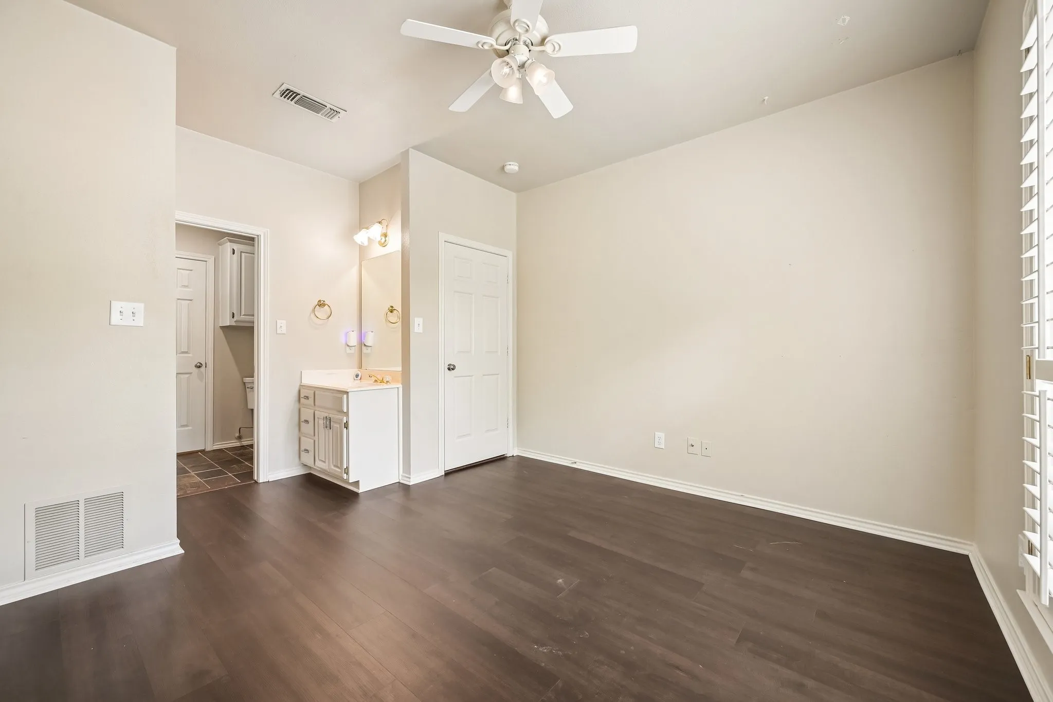 Dark wood-finish flooring with light-toned walls