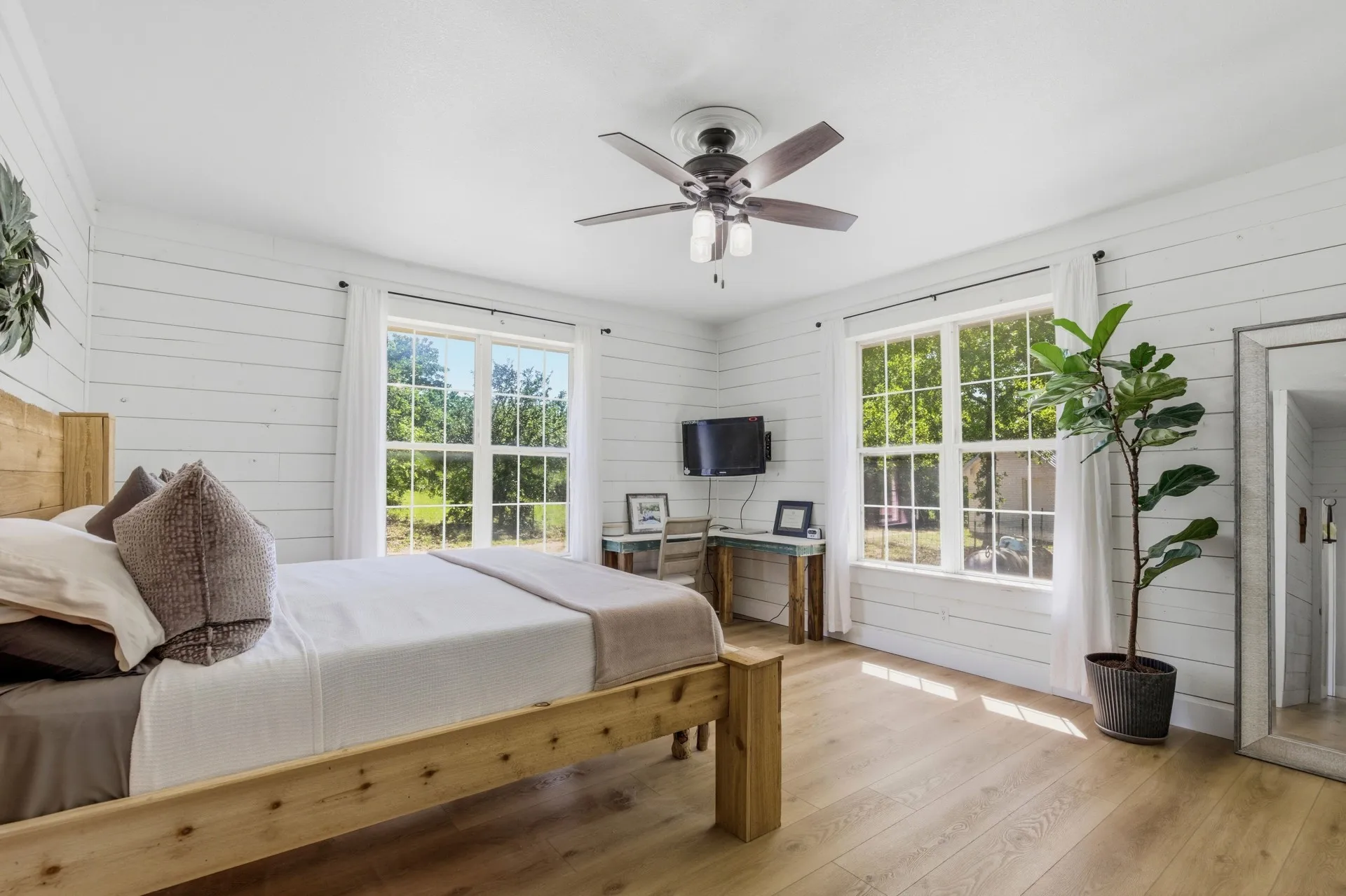 White shiplap walls complement light wood-finish flooring