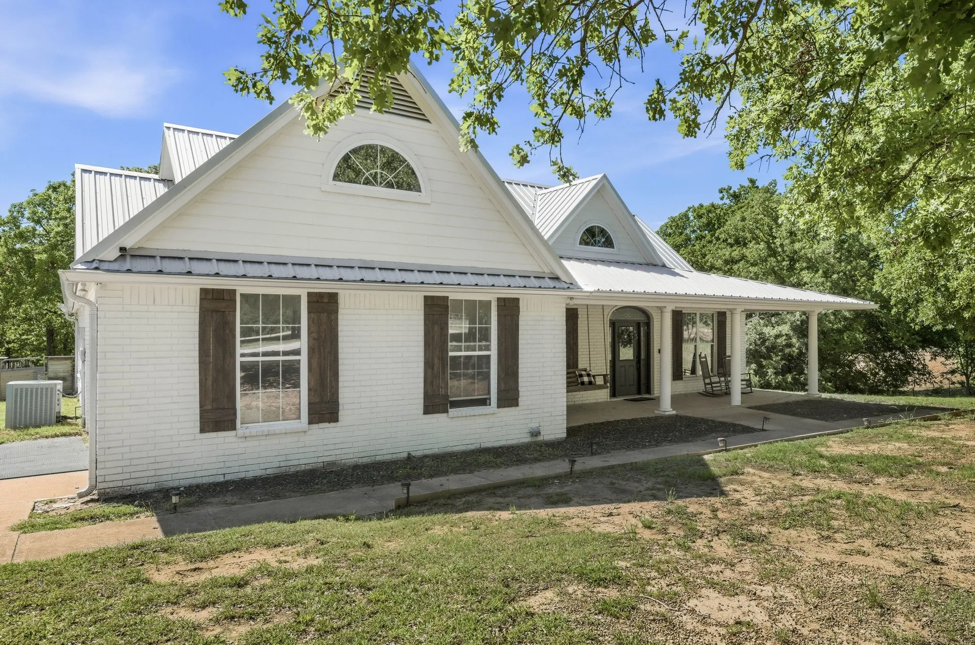 White brick exterior with a metal roof