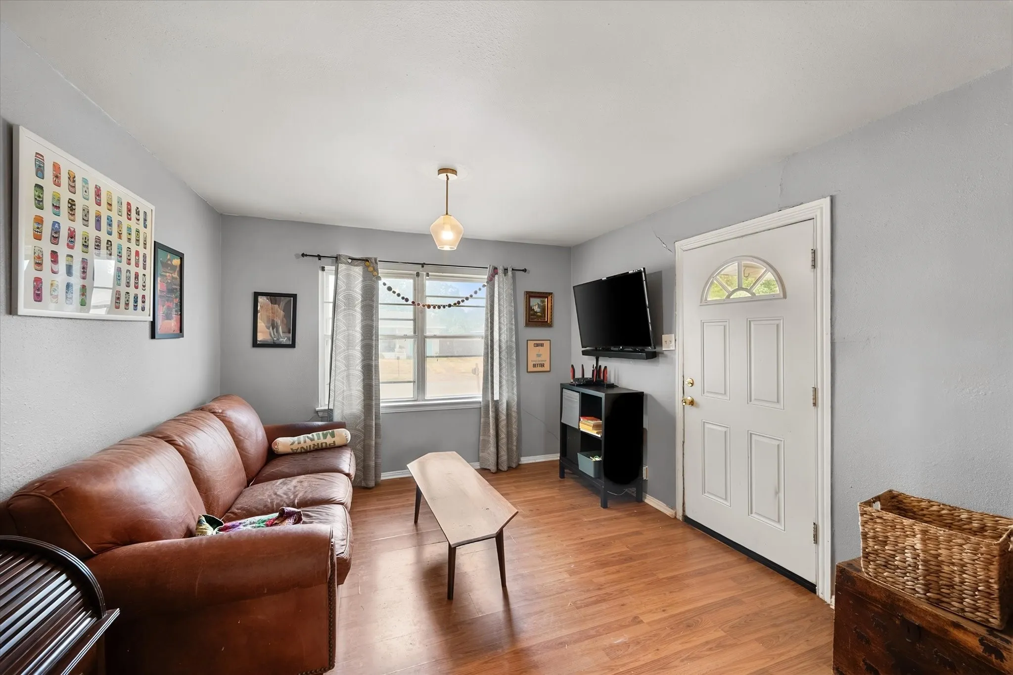 Wood-finish flooring throughout, complemented by light grey walls