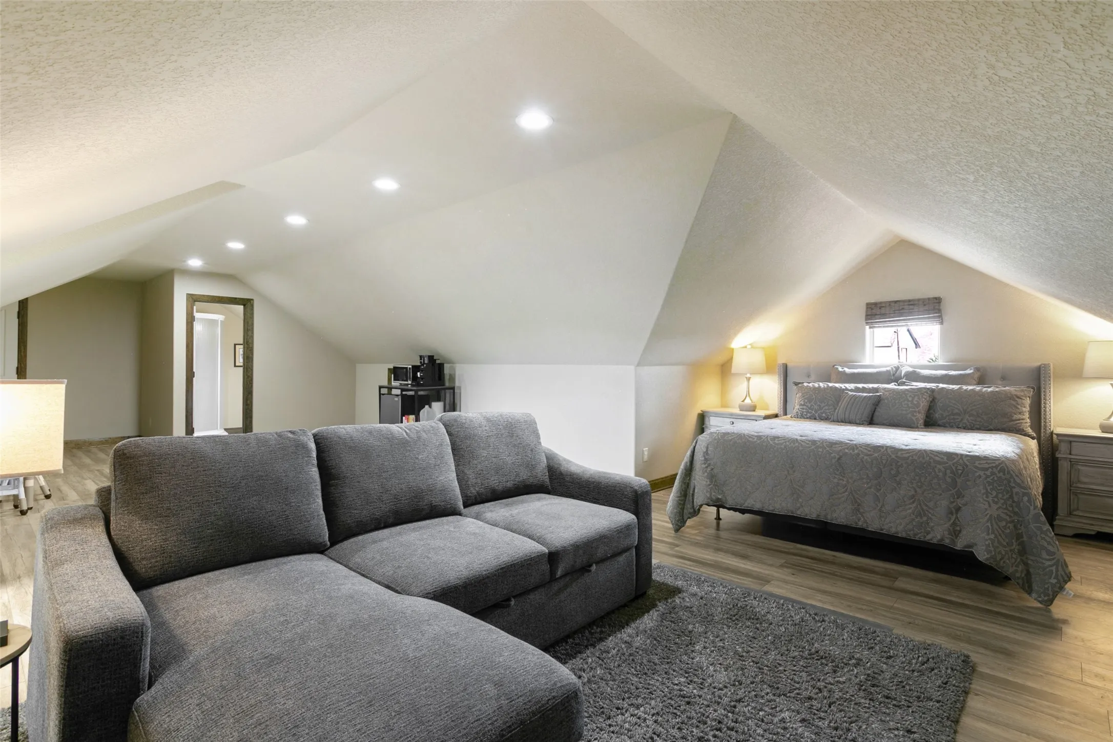 Huge finished area above garage being used as guest quarters with full bathroom in next picture.