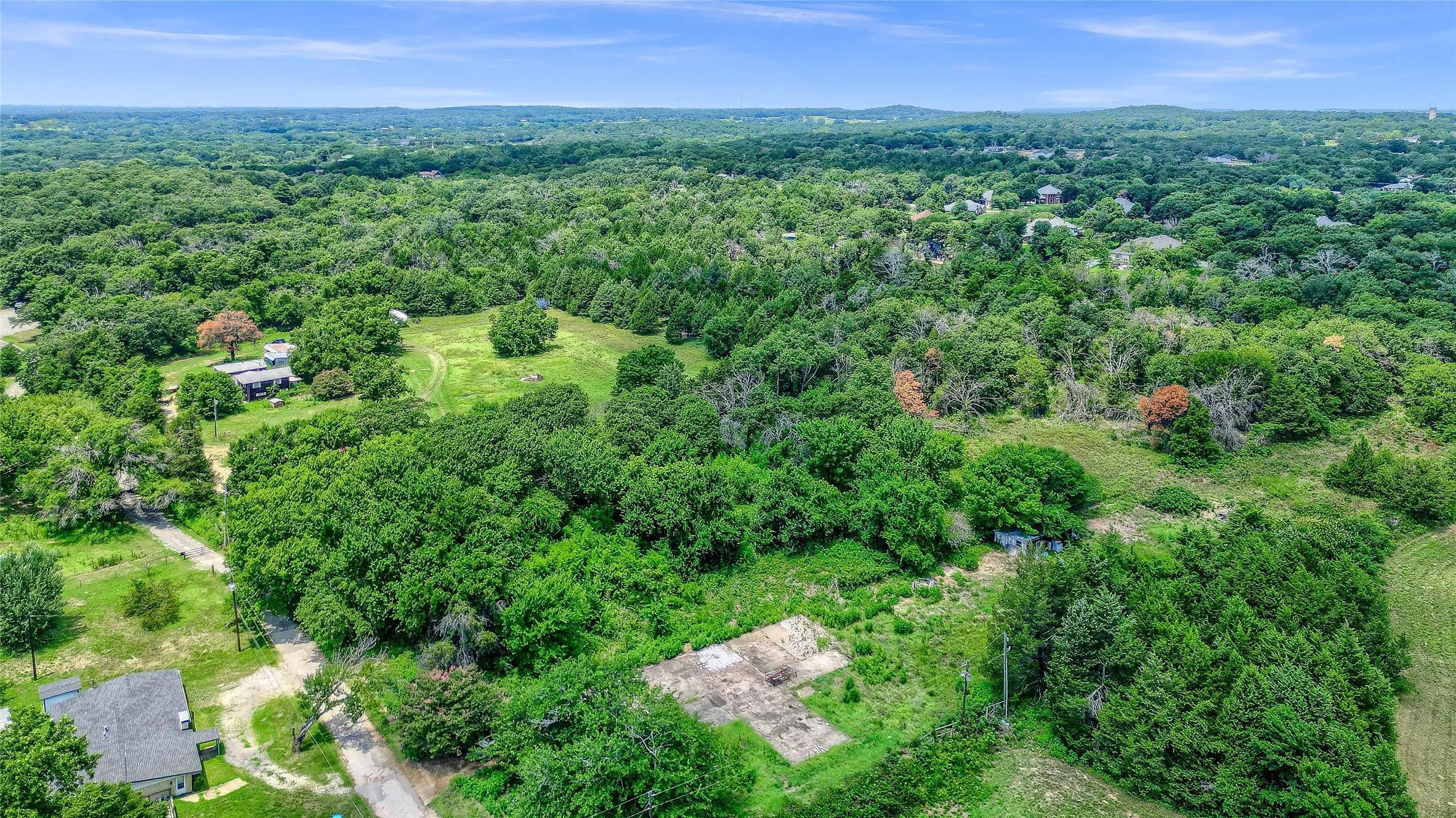 Expansive wooded acreage with a cleared building site