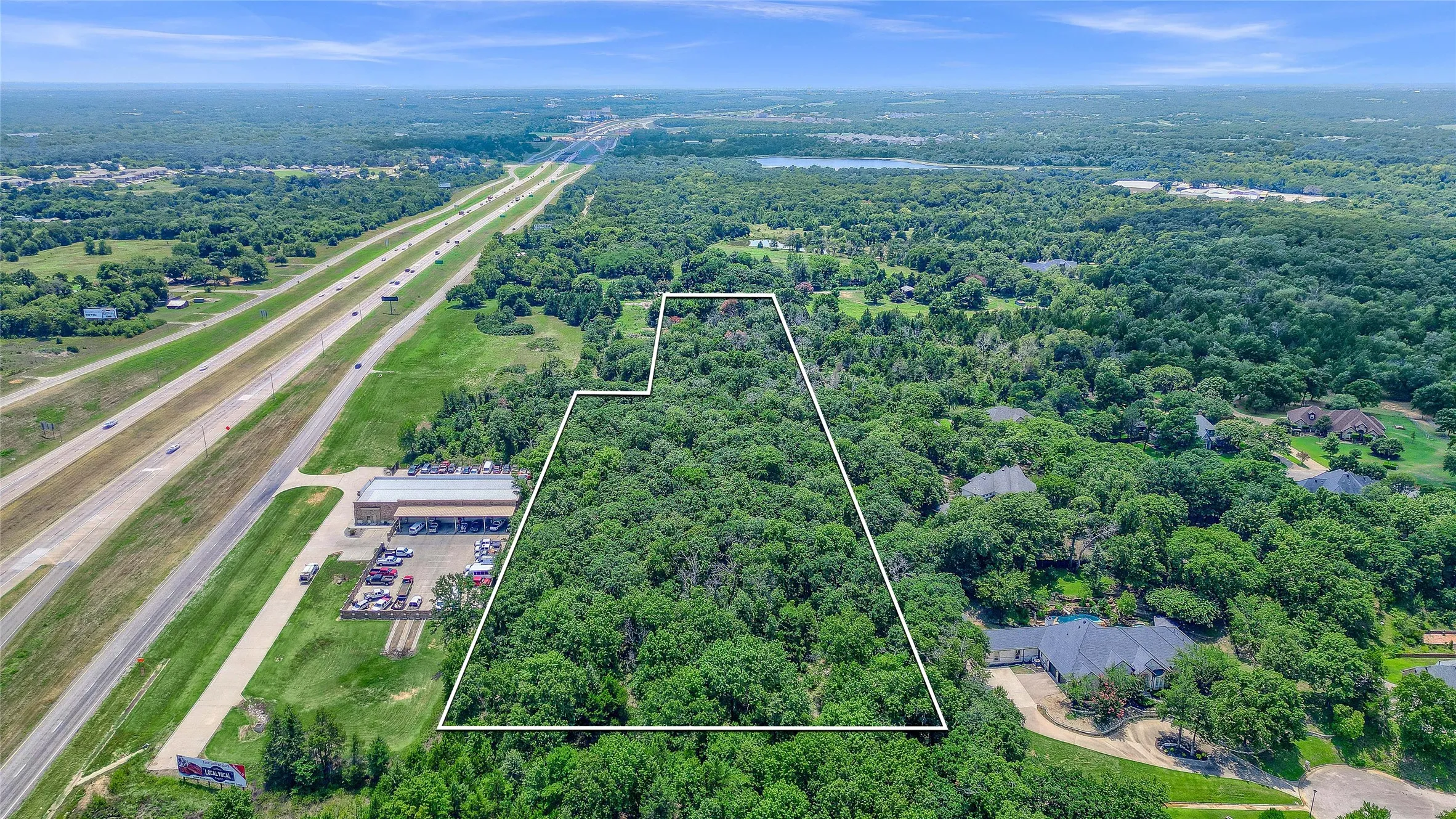 Expansive wooded acreage featuring diverse tree cover and a defined property boundary