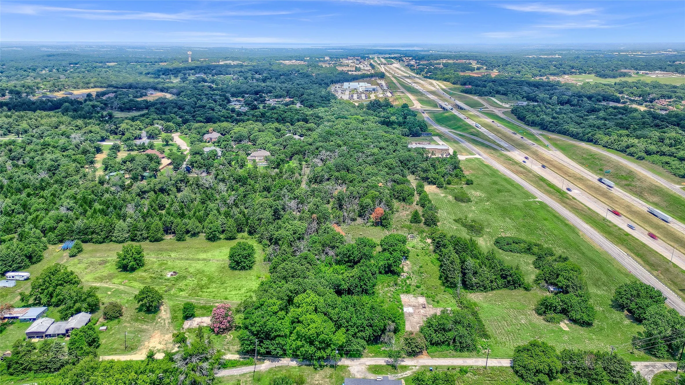 Expansive land parcel with abundant mature trees and open green spaces