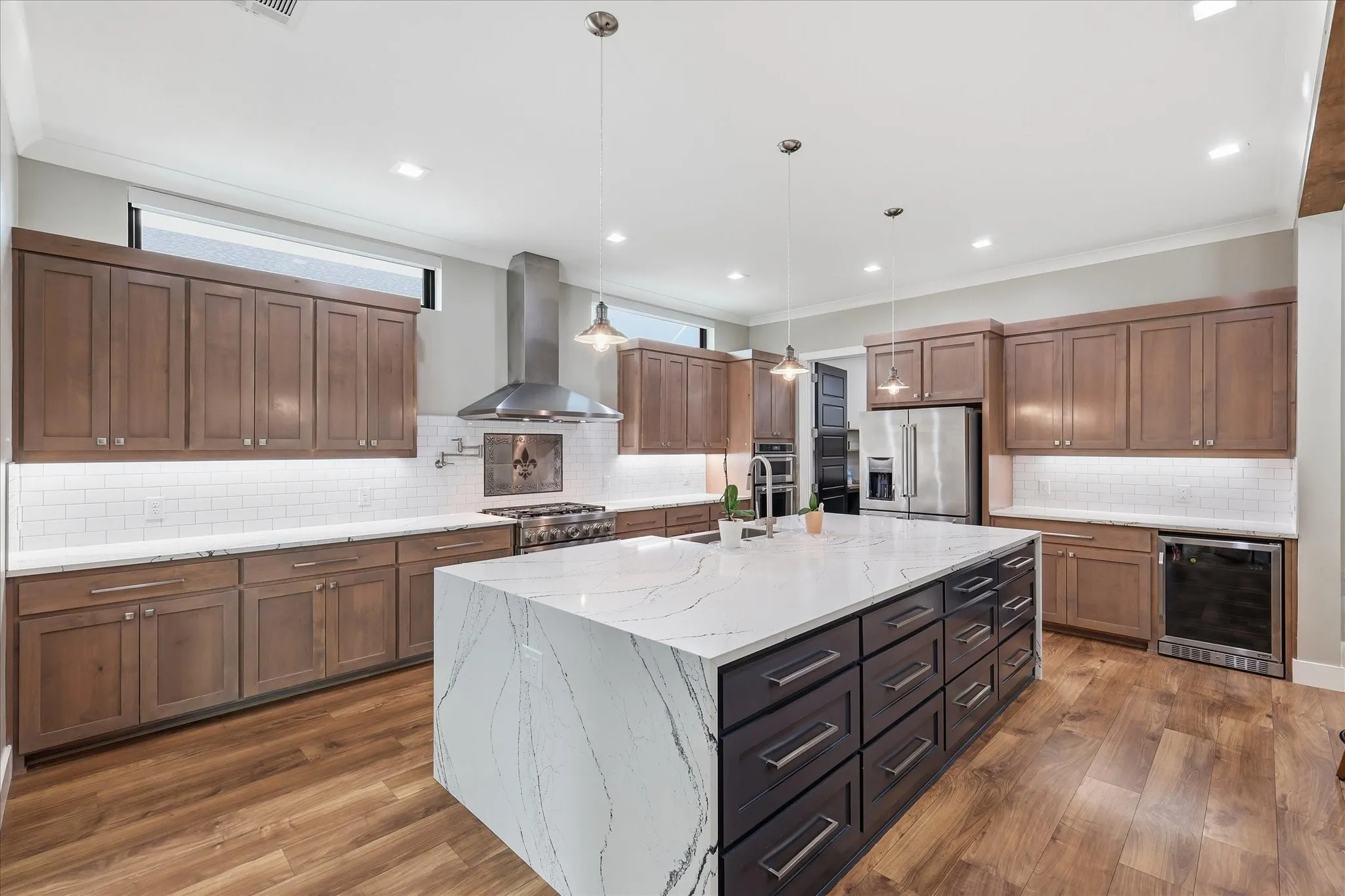 View of kitchen island, cabinetry, wine fridge