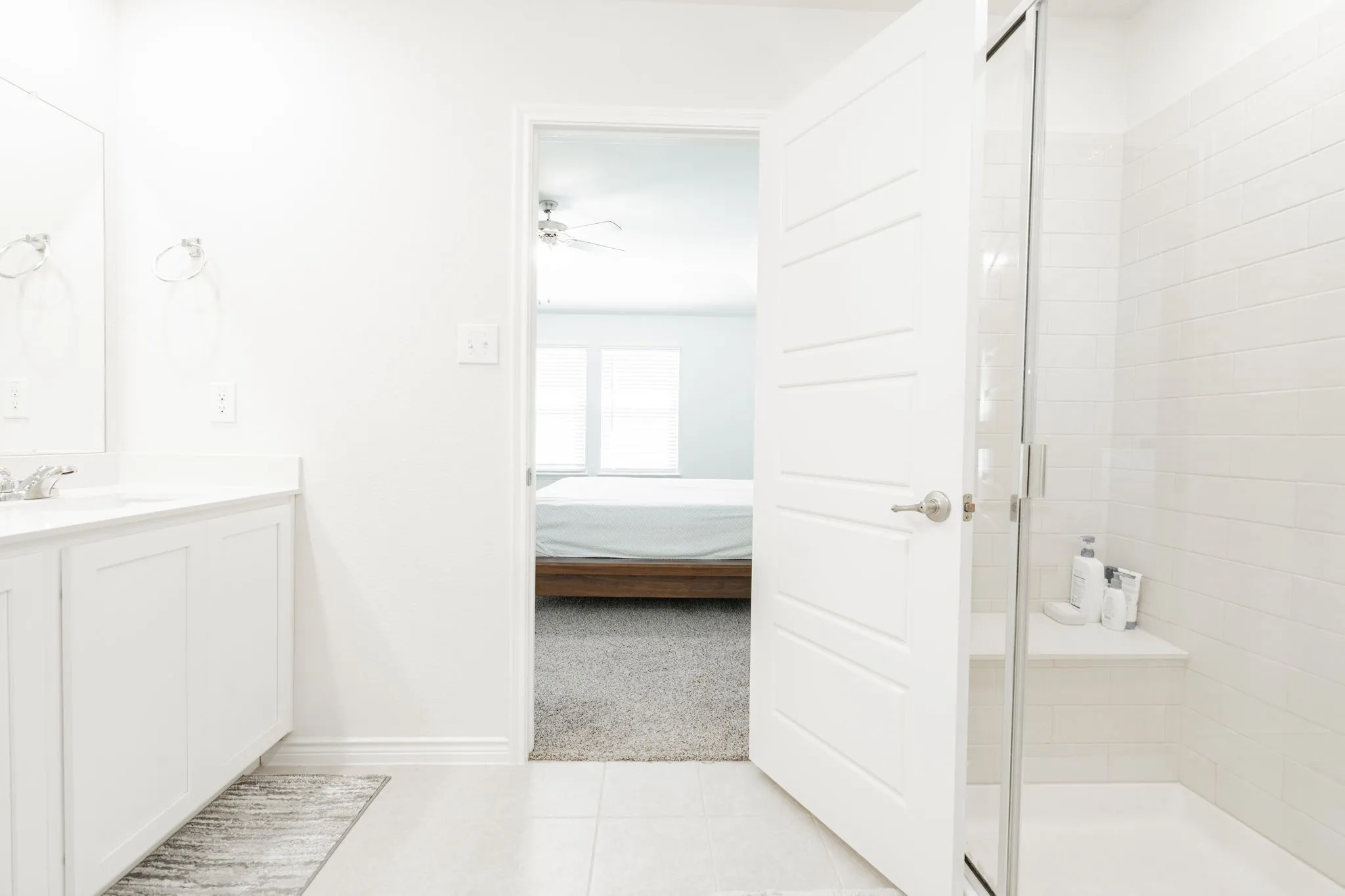 White vanity with integrated sink, chrome-finish faucet, and modern flat-panel cabinetry