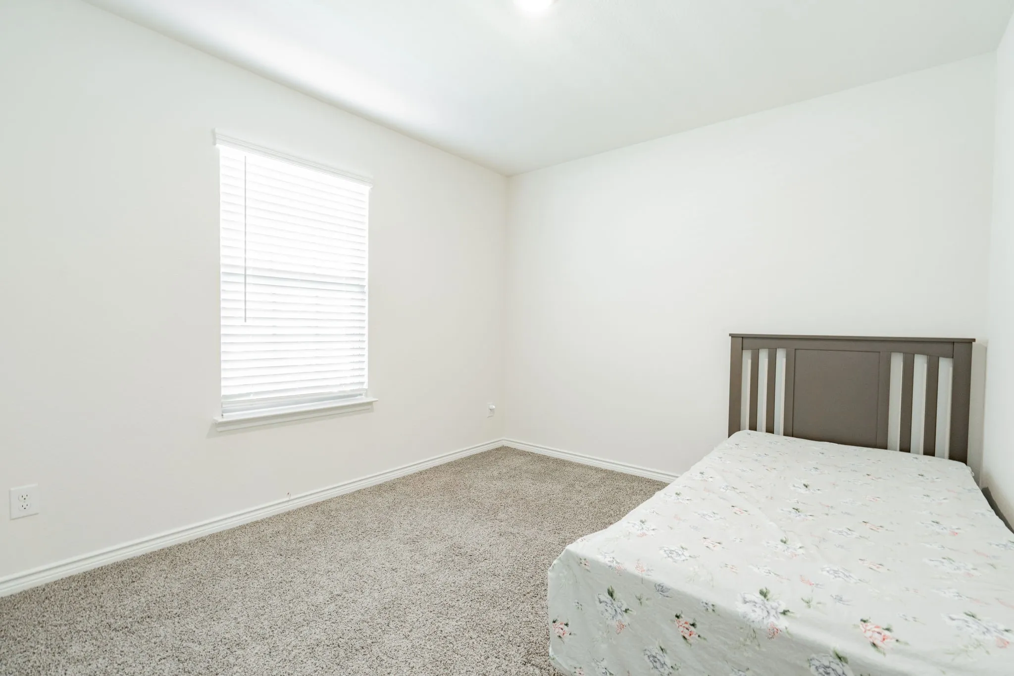 Recessed lighting, neutral wall paint, carpet flooring, window with blinds