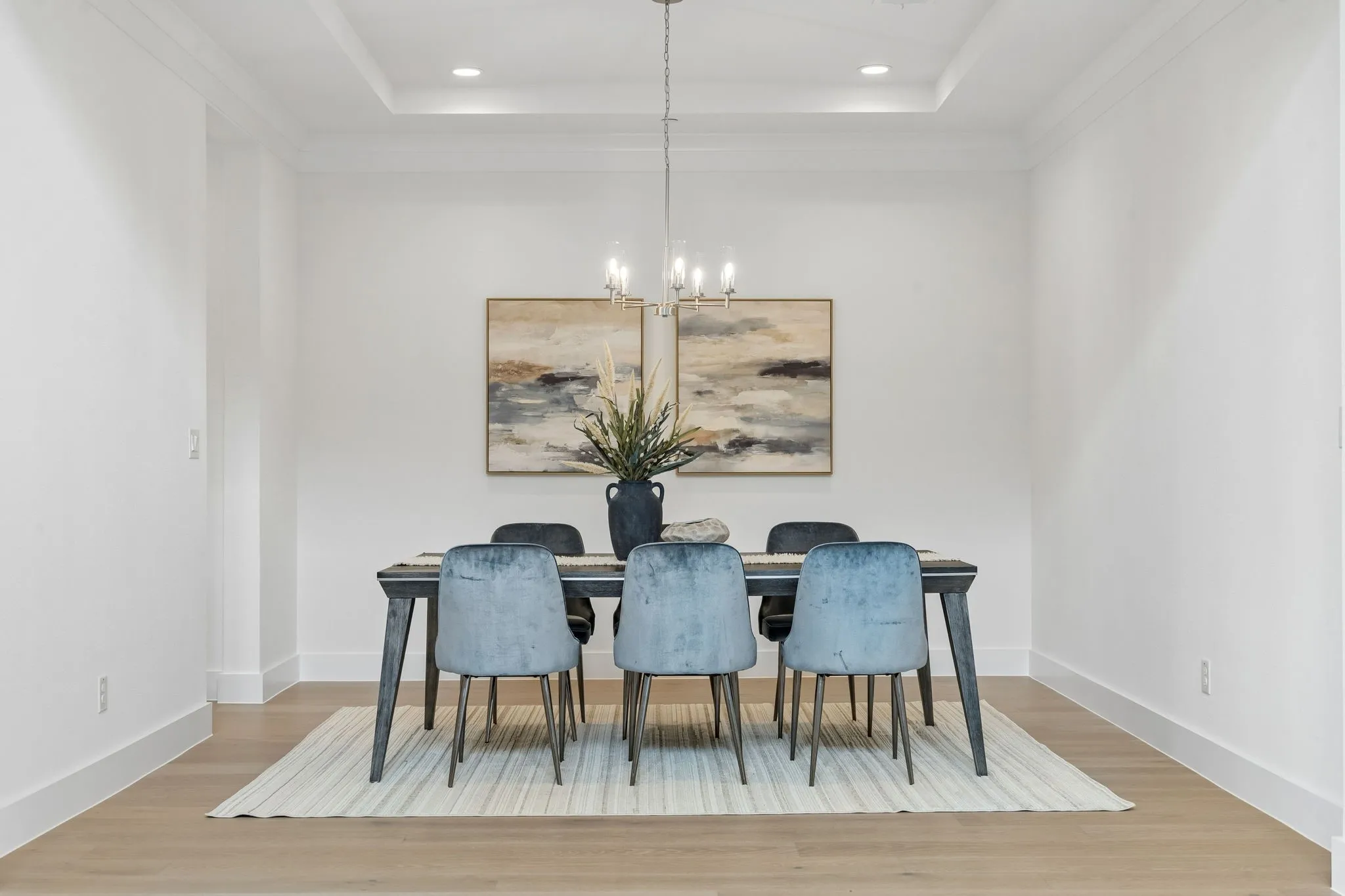 Recessed lighting, wood-finish flooring, and a tray ceiling with crown molding