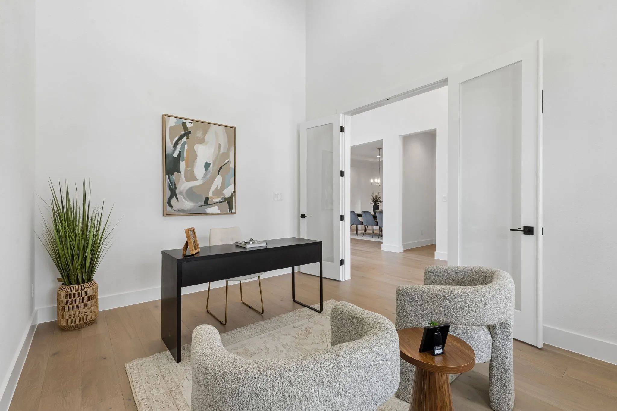 Vaulted ceilings, wood-finish flooring, and double doors with frosted panels